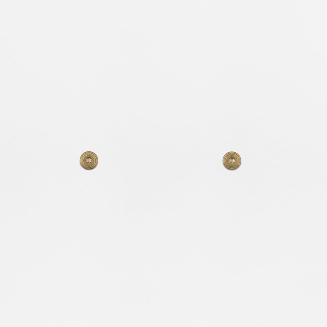 Pair of Belmont Hung Window Stops in Antique Brass finish, mounted on a plain white surface.