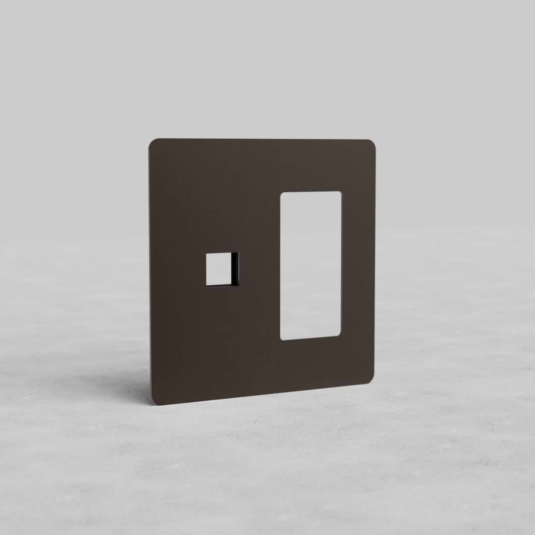 Bronze 2G Outlet & Keystone Plate Kew US with two rectangular cutouts, shown on a light gray surface.