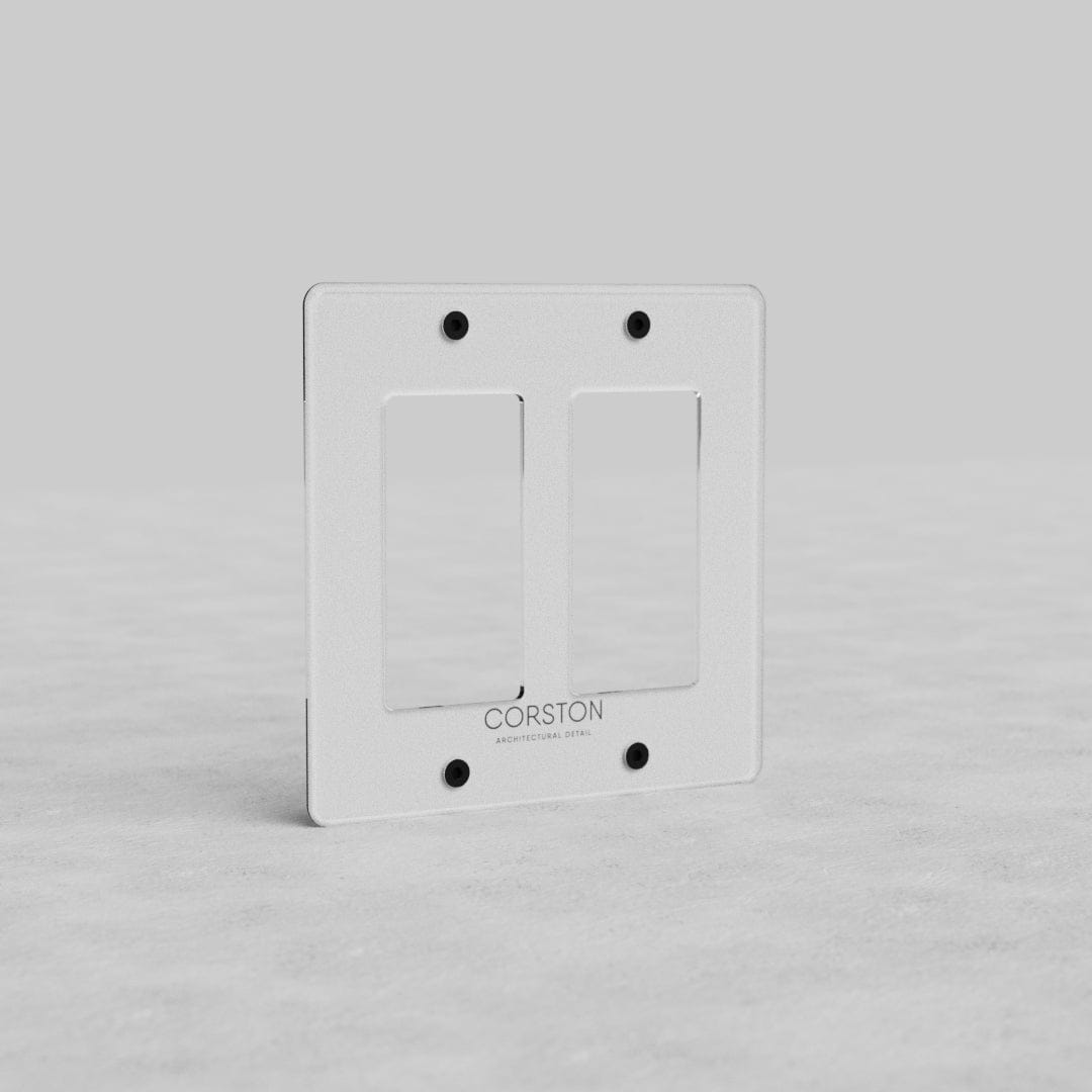 Clear 2G Outlet Plate Kew US with two rectangular outlet openings, four screw holes, and 'CORSTON' label.