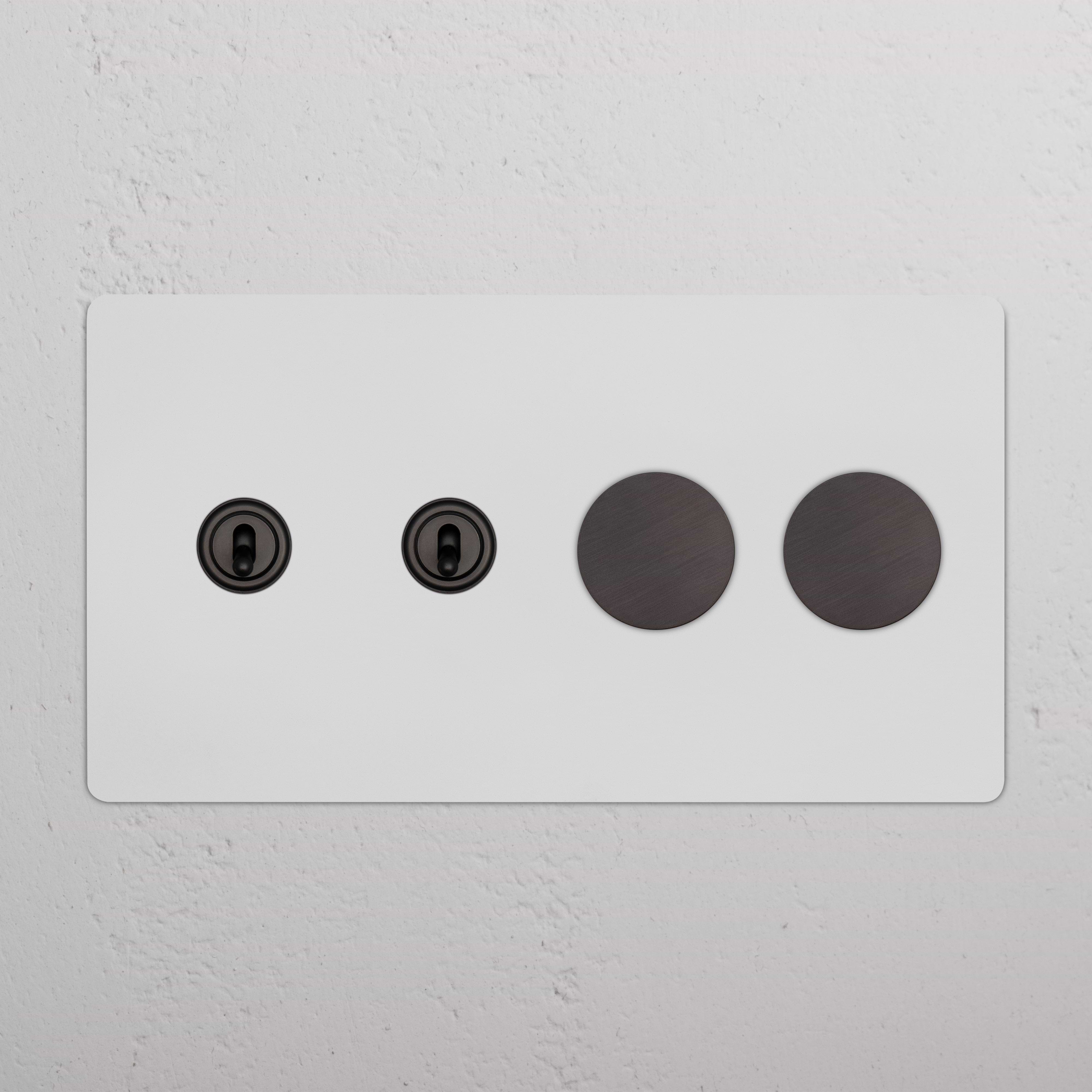 Kew 4G paintable bronze switch with two toggle switches and two dimmer knobs on a rectangular plate.