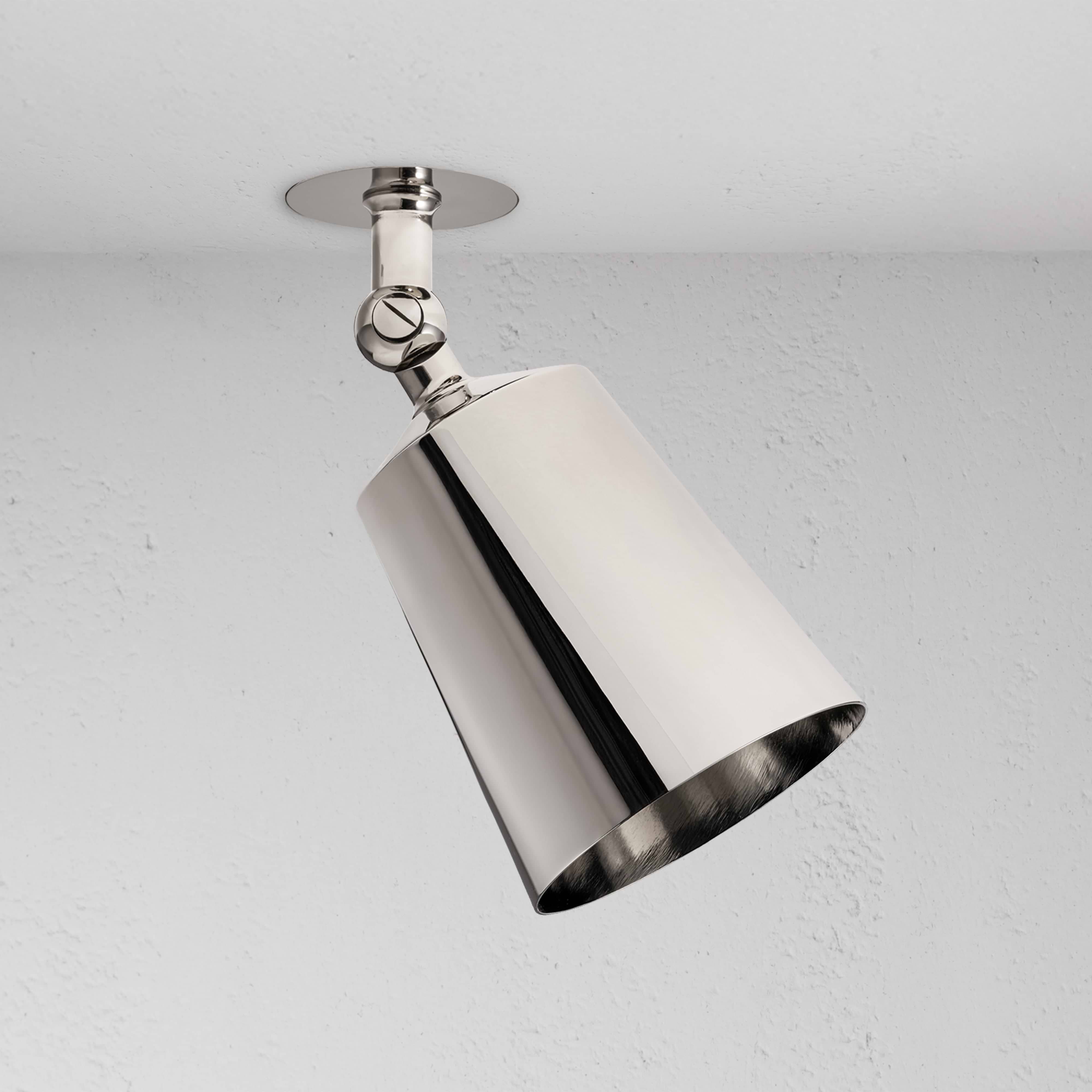 Perryn Single 70mm Spotlight in polished nickel with angled cylindrical shade, mounted on a white ceiling.