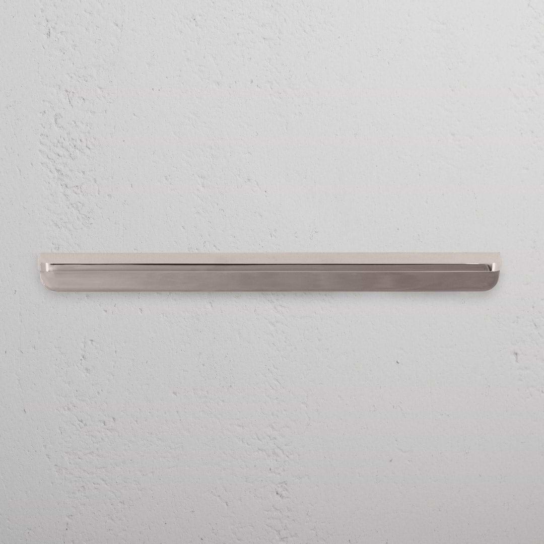 Medium-sized Oxford Furniture Handle in polished nickel finish, shown mounted on a light-colored surface.