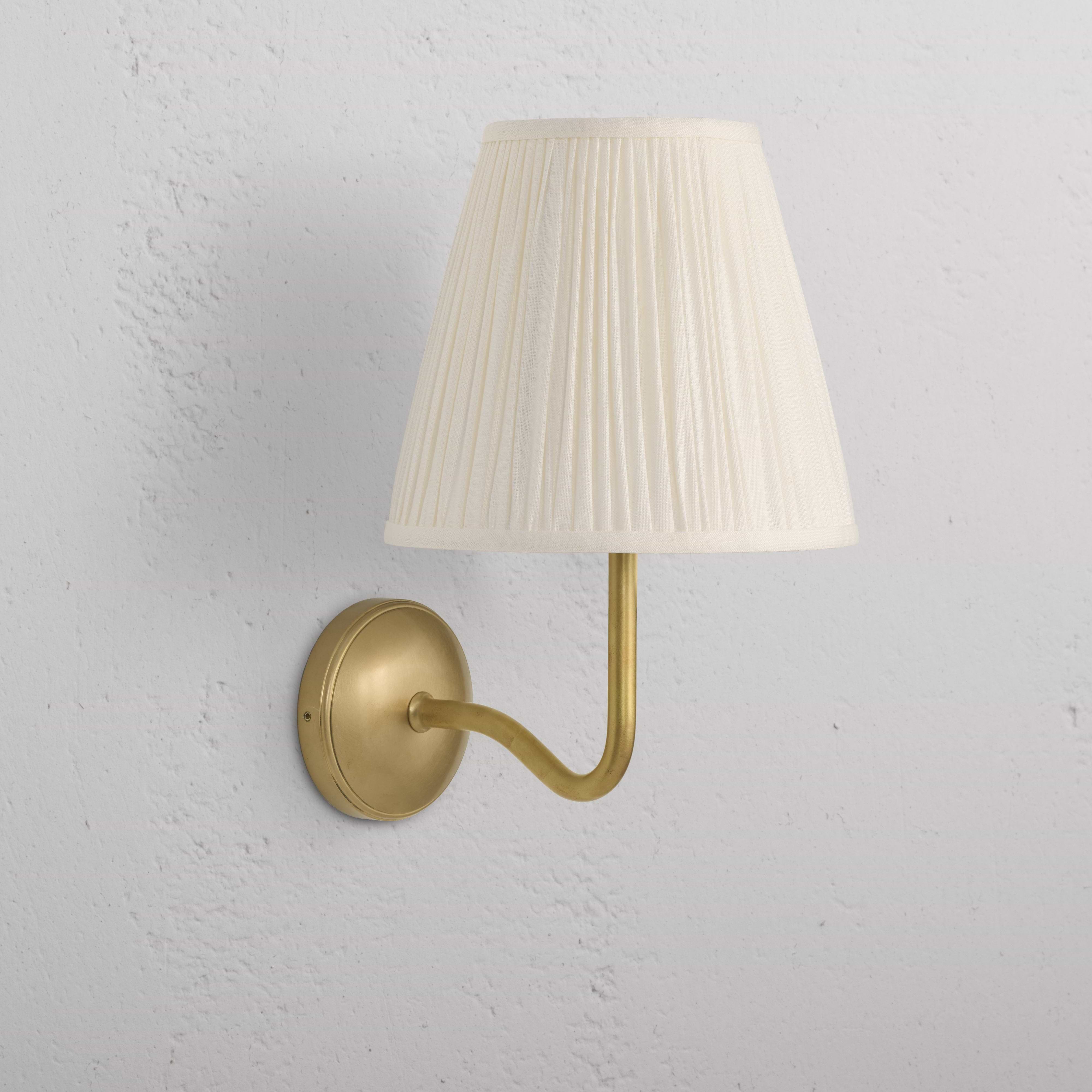 Large Malvern Wall Light in Alabaster White with antique brass finish and pleated cream lampshade, wall-mounted.
