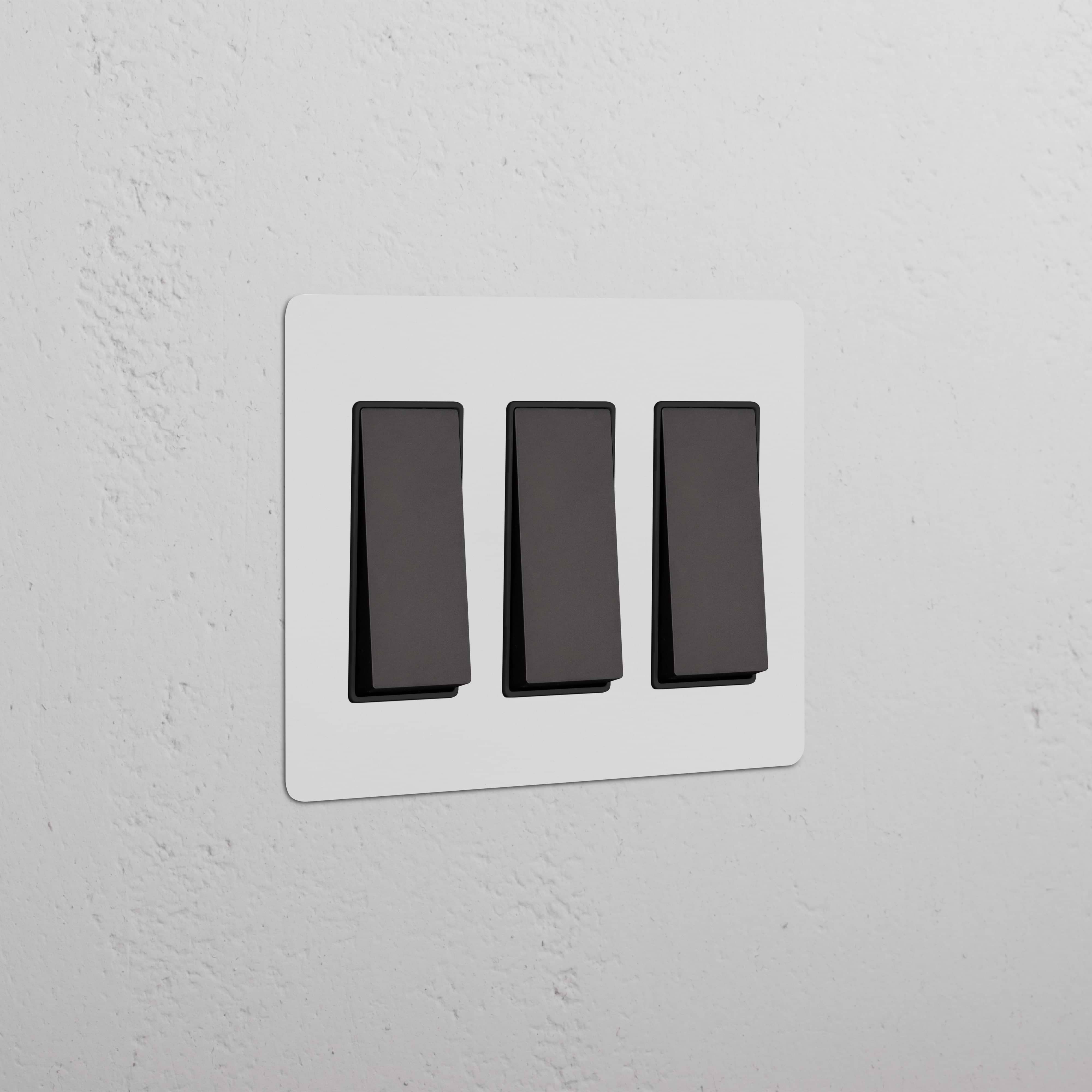 Kew 3G Rocker Switch in Paintable Bronze Black finish, shown on a white wall plate.