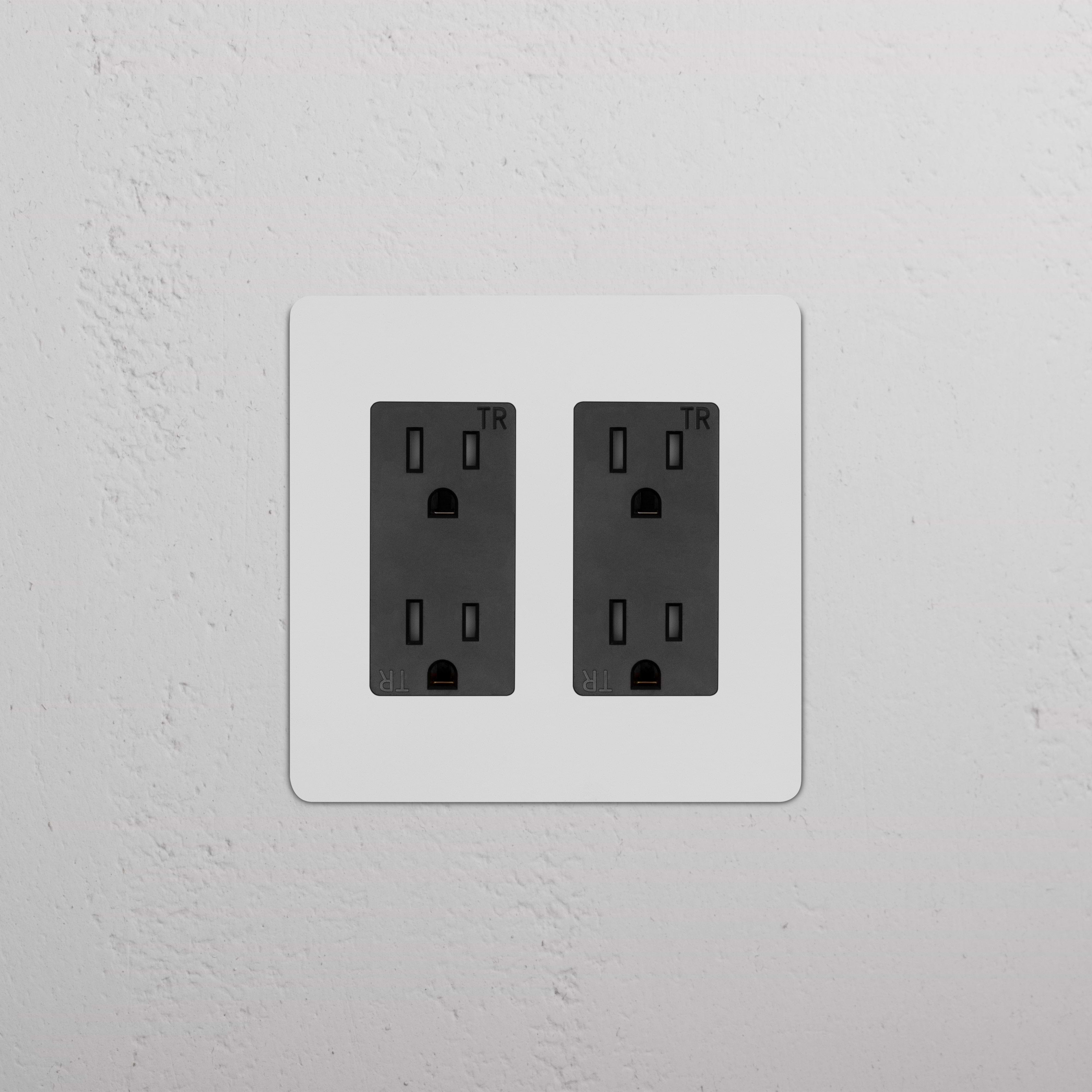 Kew 2G Outlet - Paintable Black: double power socket with paintable black finish on a wall.