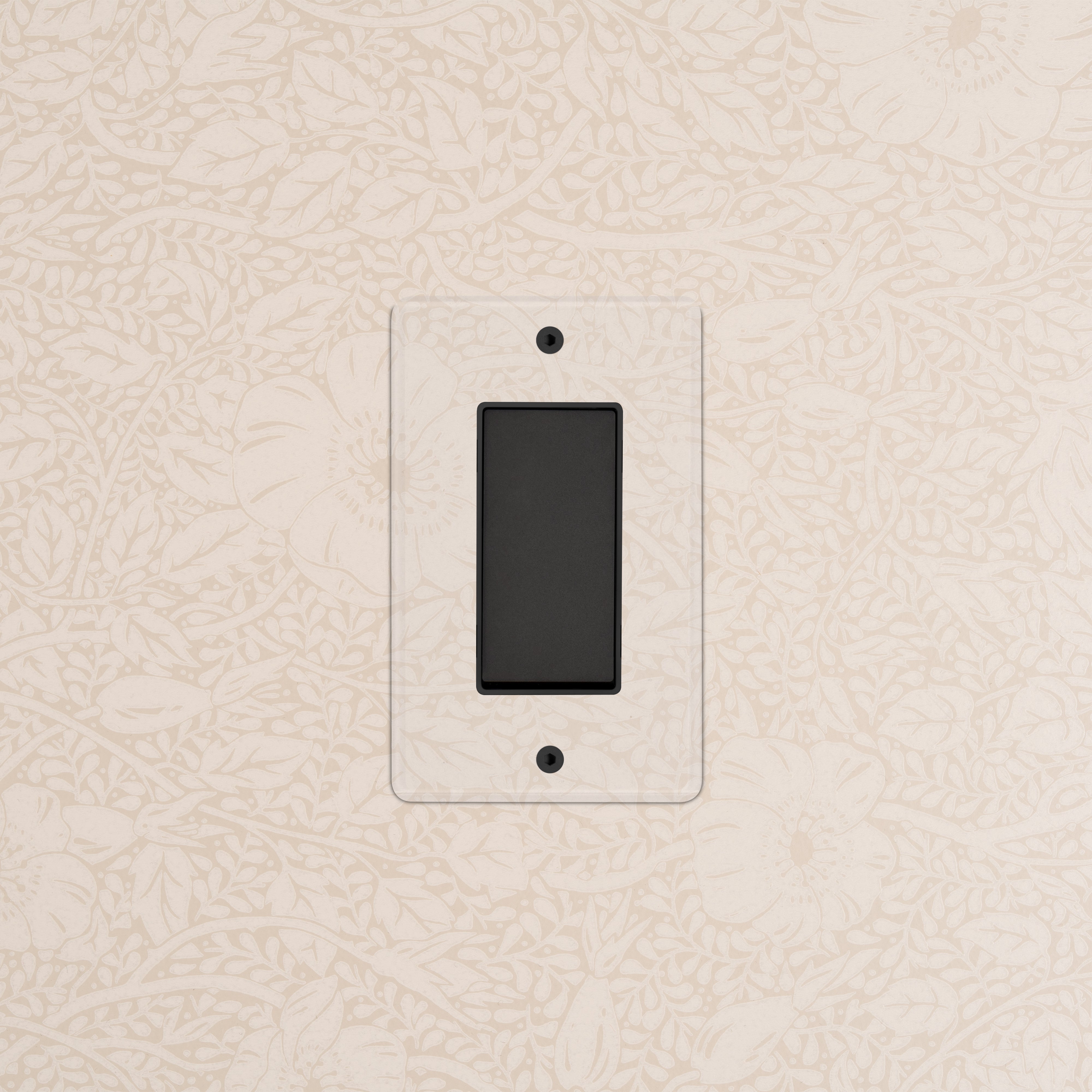 Kew 1G Four Way Rocker Switch in Clear Bronze Black with clear cover plate on a patterned wall.