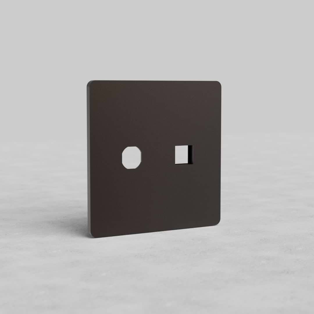 Bronze 2G Switch & Keystone Plate Grove US wall plate with round and square cutouts on a light background.