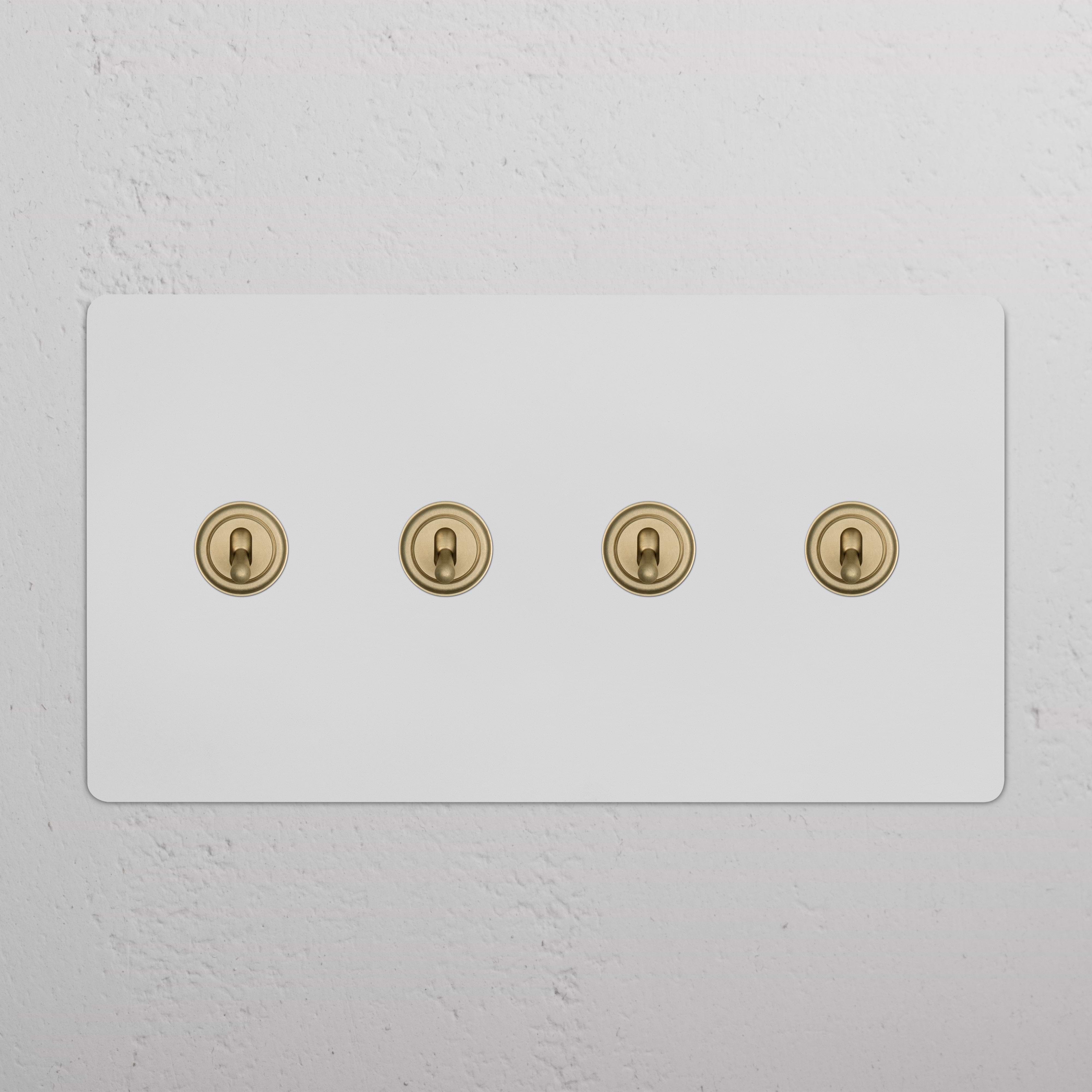 Kew 4G toggle switch in paintable antique brass finish with four horizontally aligned toggle switches.