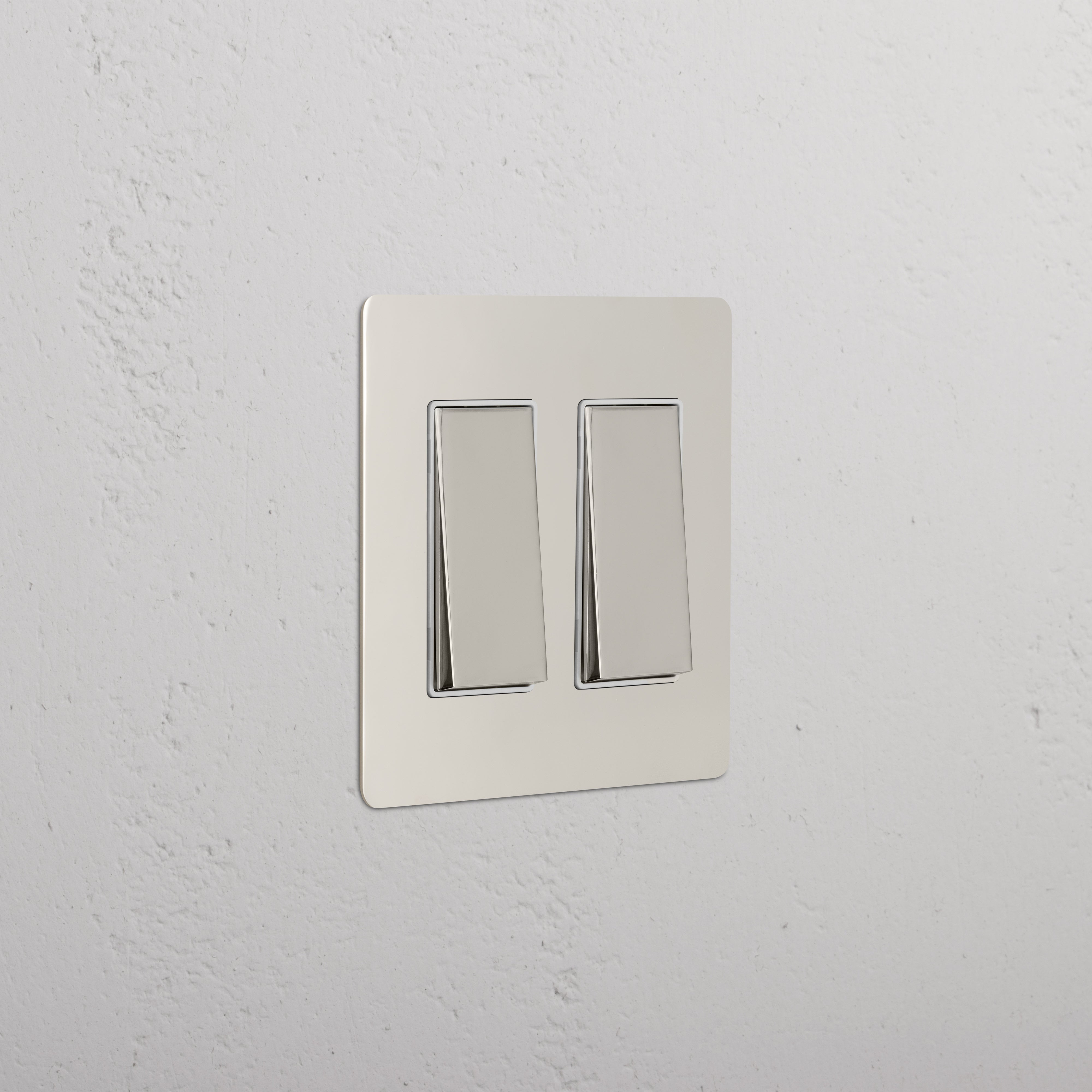 Kew 2G Rocker Switch in polished nickel with white finish, shown mounted on a white textured wall.