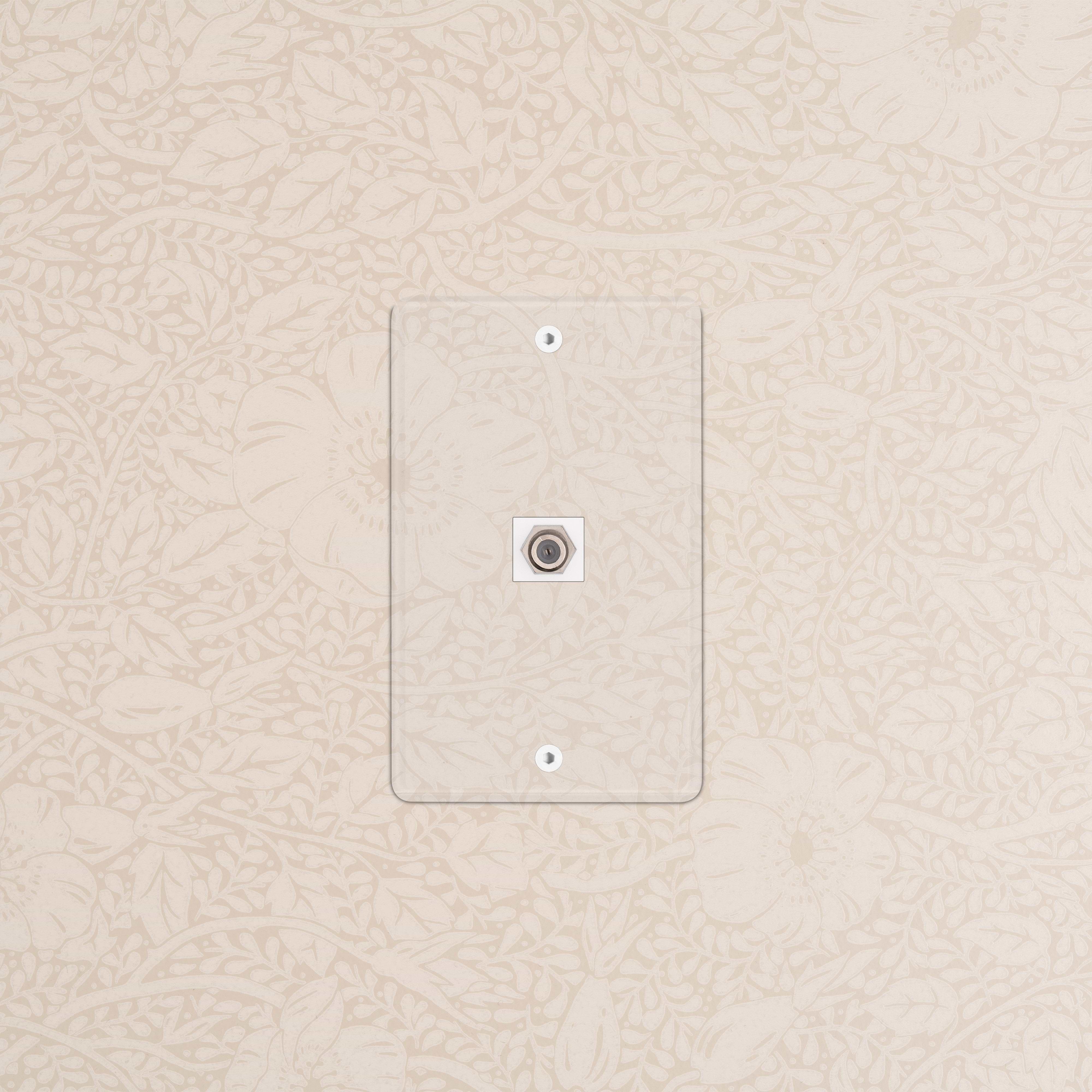 Kew 1G Satellite Keystone clear white wall plate for satellite cable connection, shown on a patterned wall.