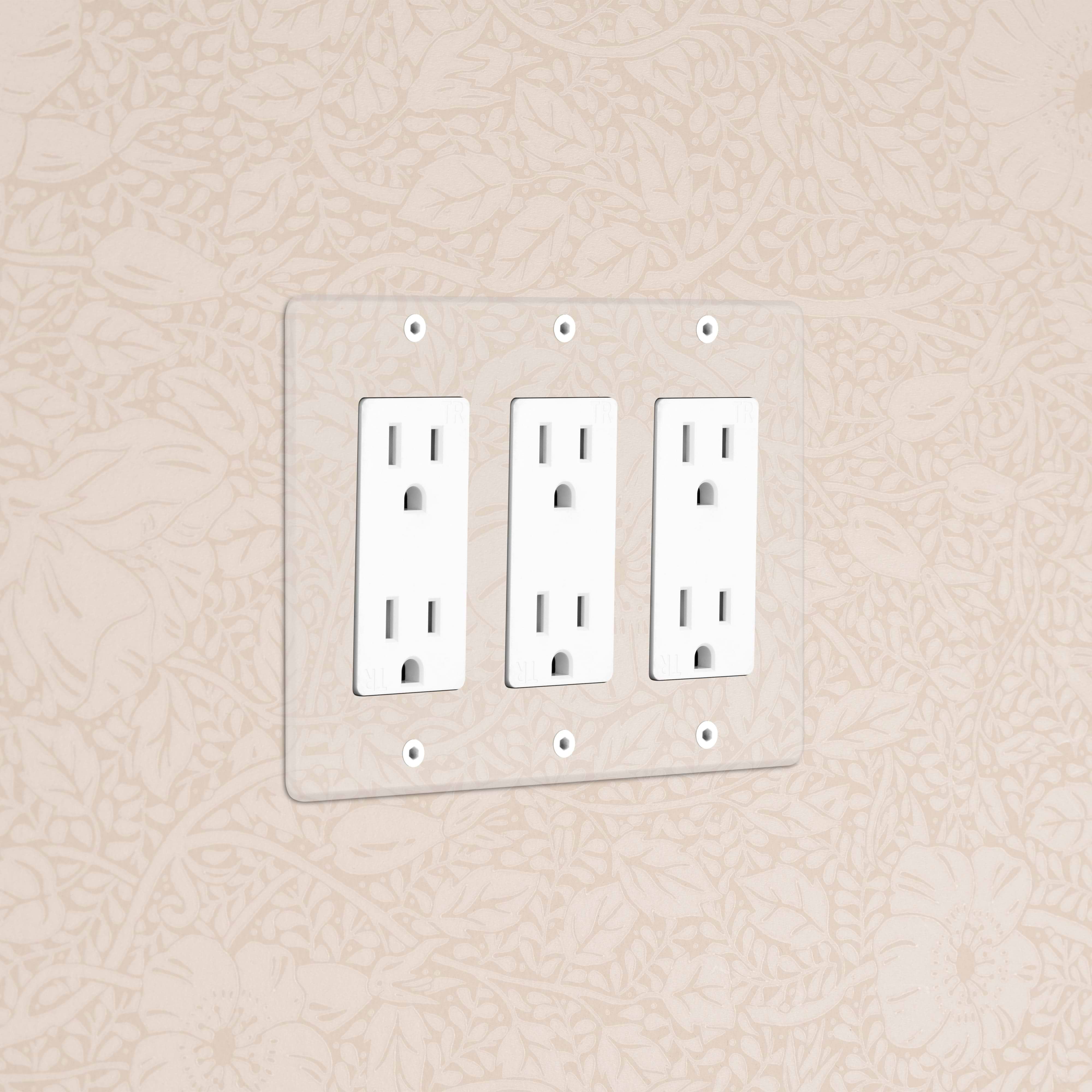 Kew 3G Outlet - Clear White electrical outlet with three sockets and a clear cover plate on a beige wall.