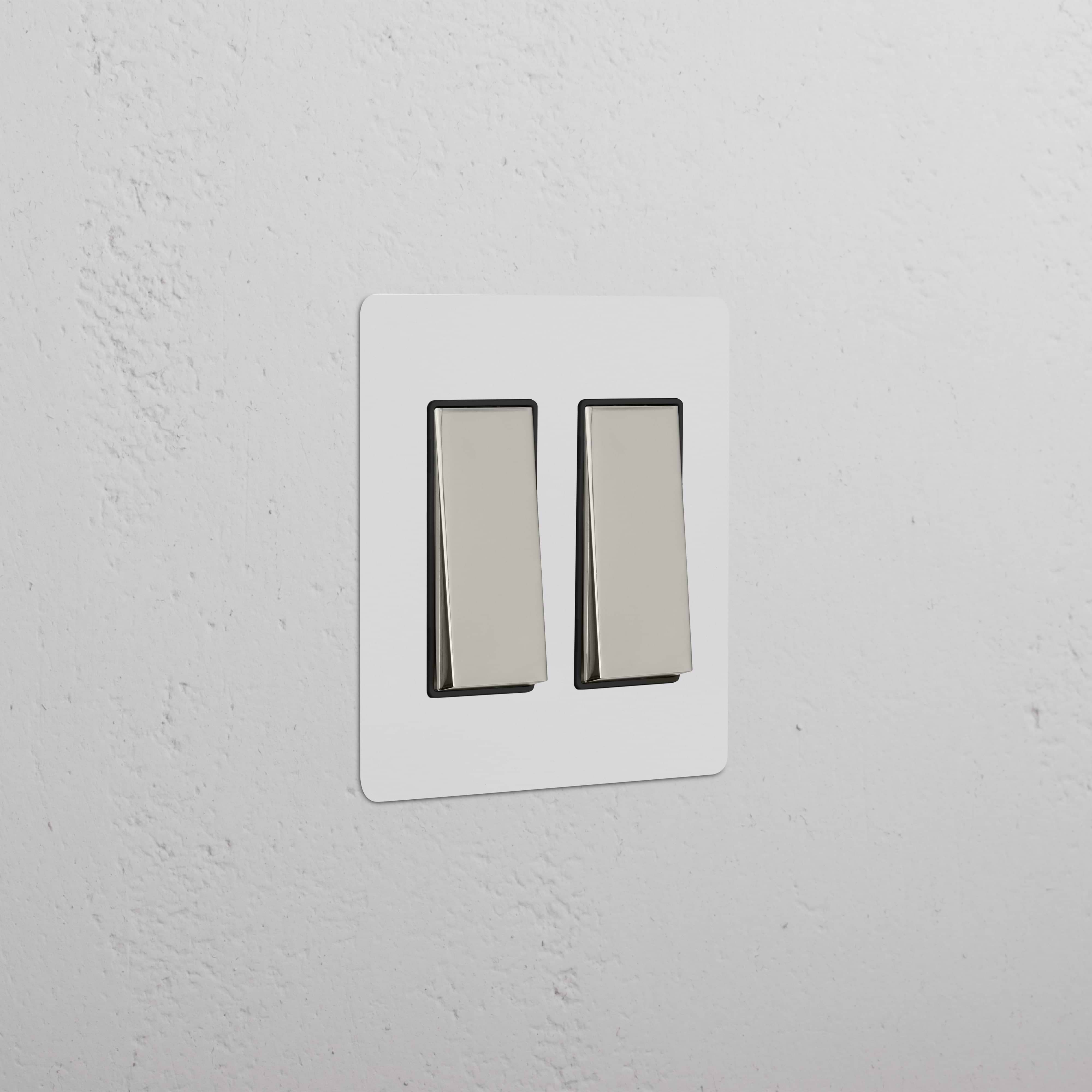 Kew 2G Rocker Switch in paintable white plate with two polished nickel black rocker switches.