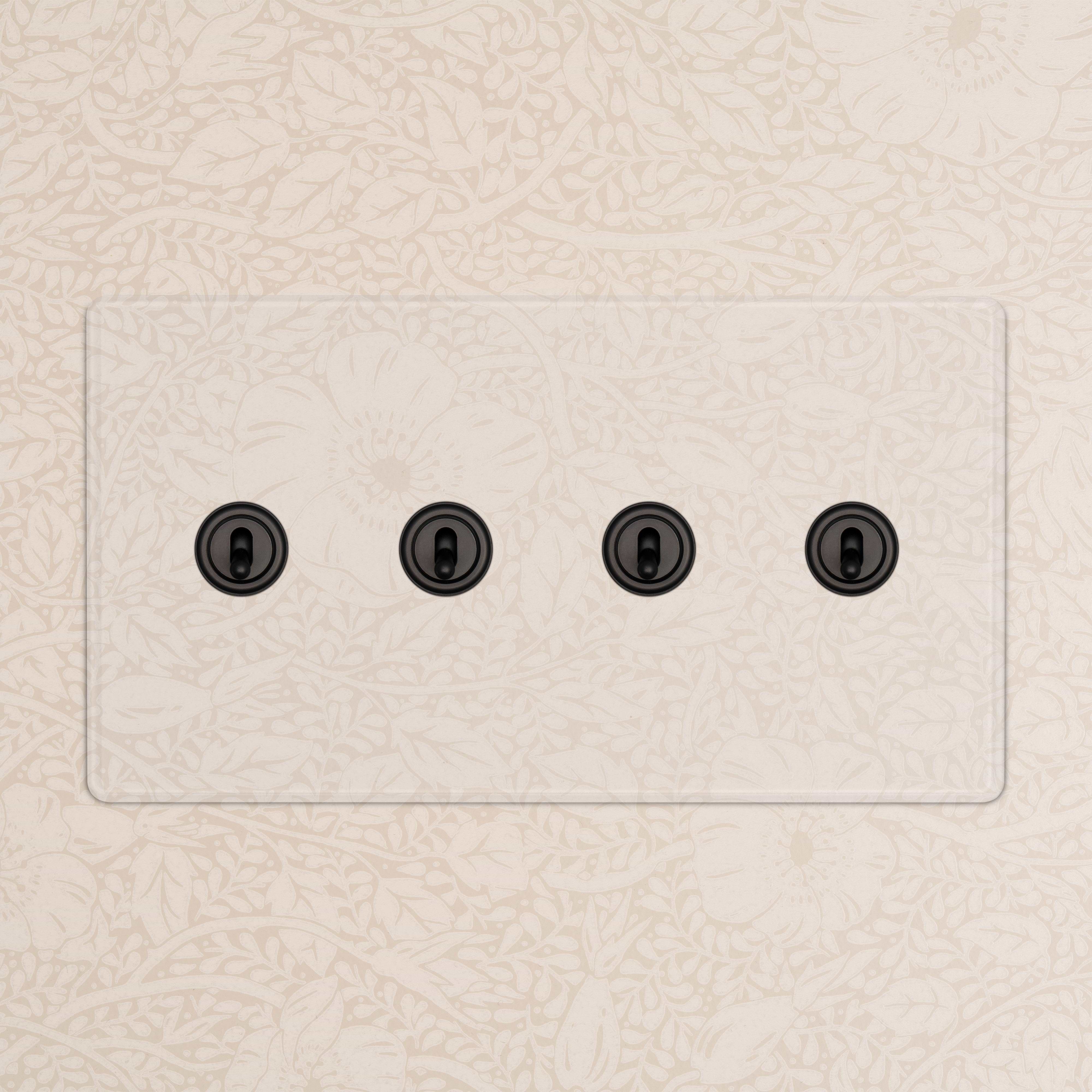 Kew 4G Toggle Switch in clear bronze finish with four black toggles, shown installed on a wall.