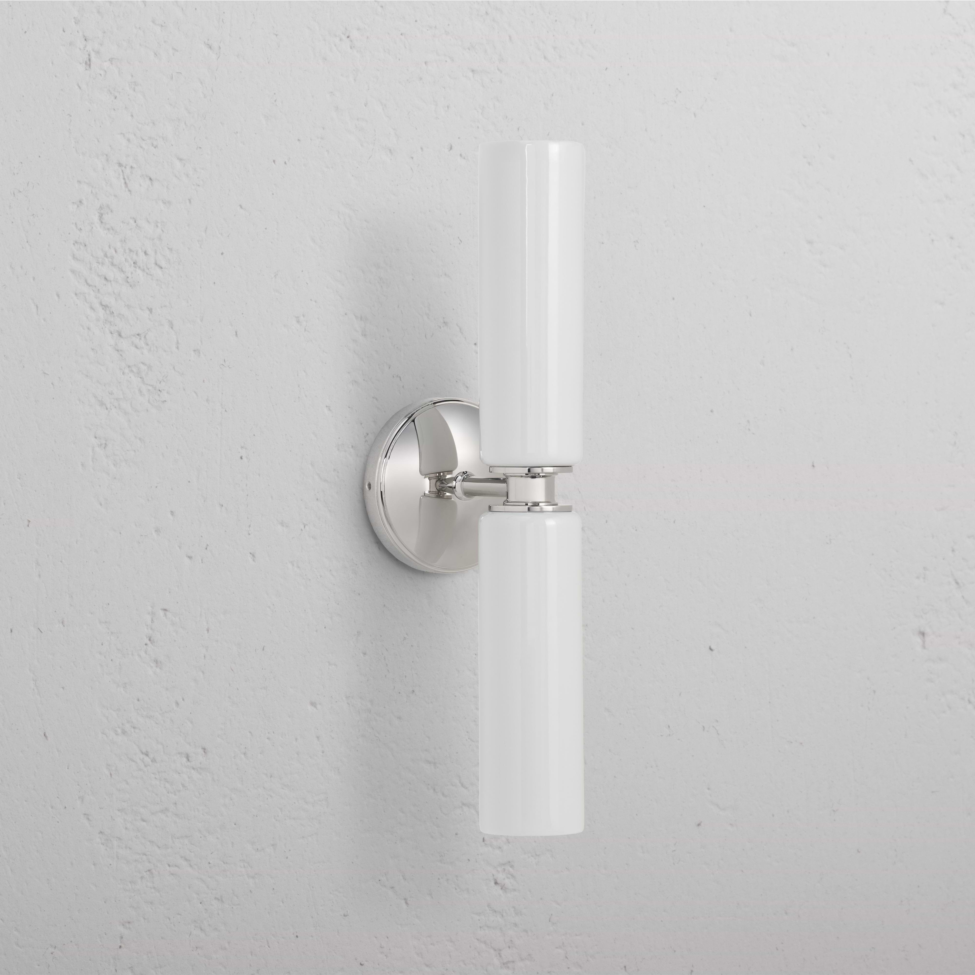 Claremont Medium Wall Light Fine Porcelain in polished nickel with twin vertical white porcelain shades.