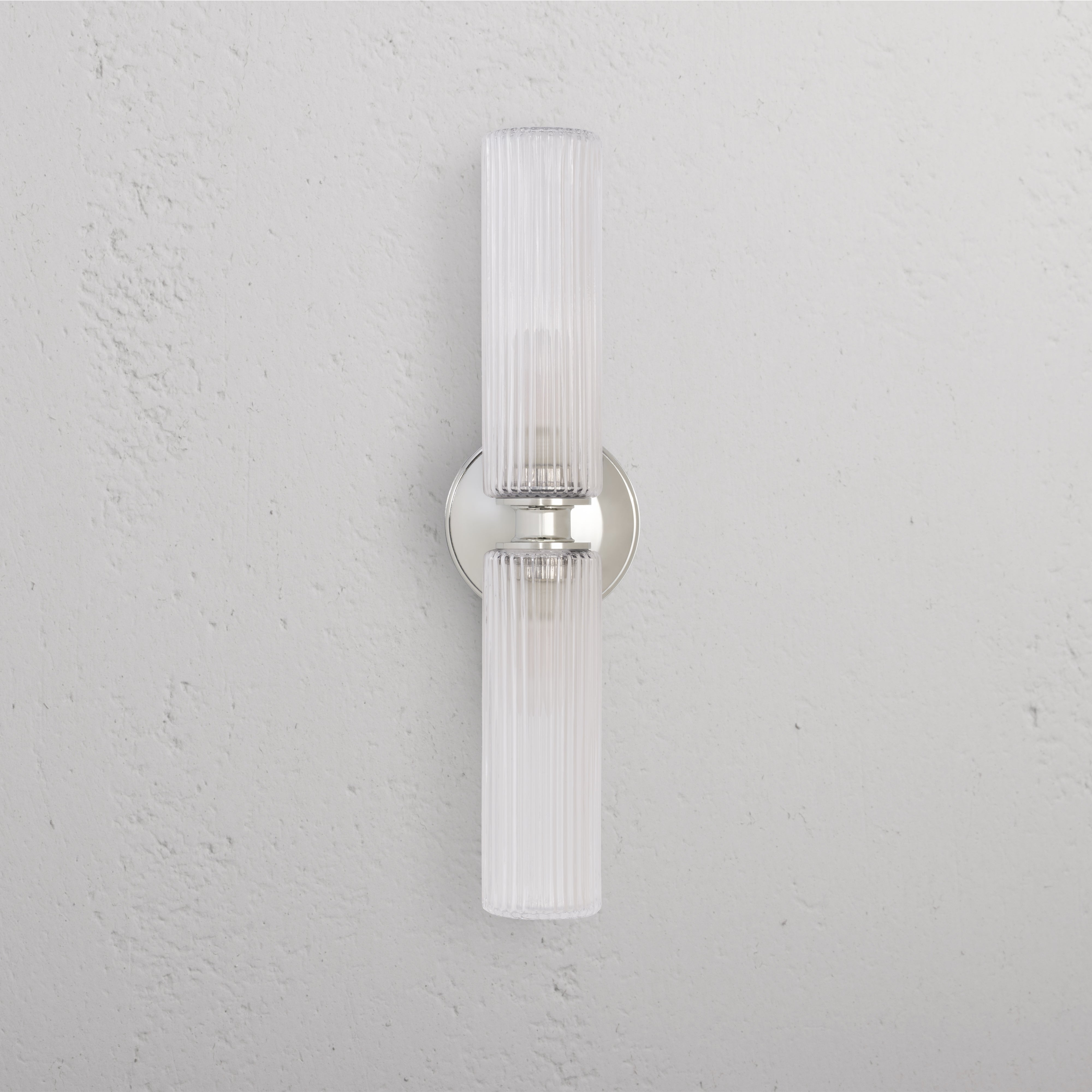 Claremont Medium Wall Light with fluted glass shades and polished nickel base, mounted on a white wall.