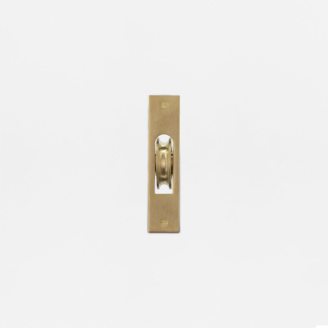 Belmont Single Hung Window Pulley in Antique Brass with exposed wheel, displayed on a white background.