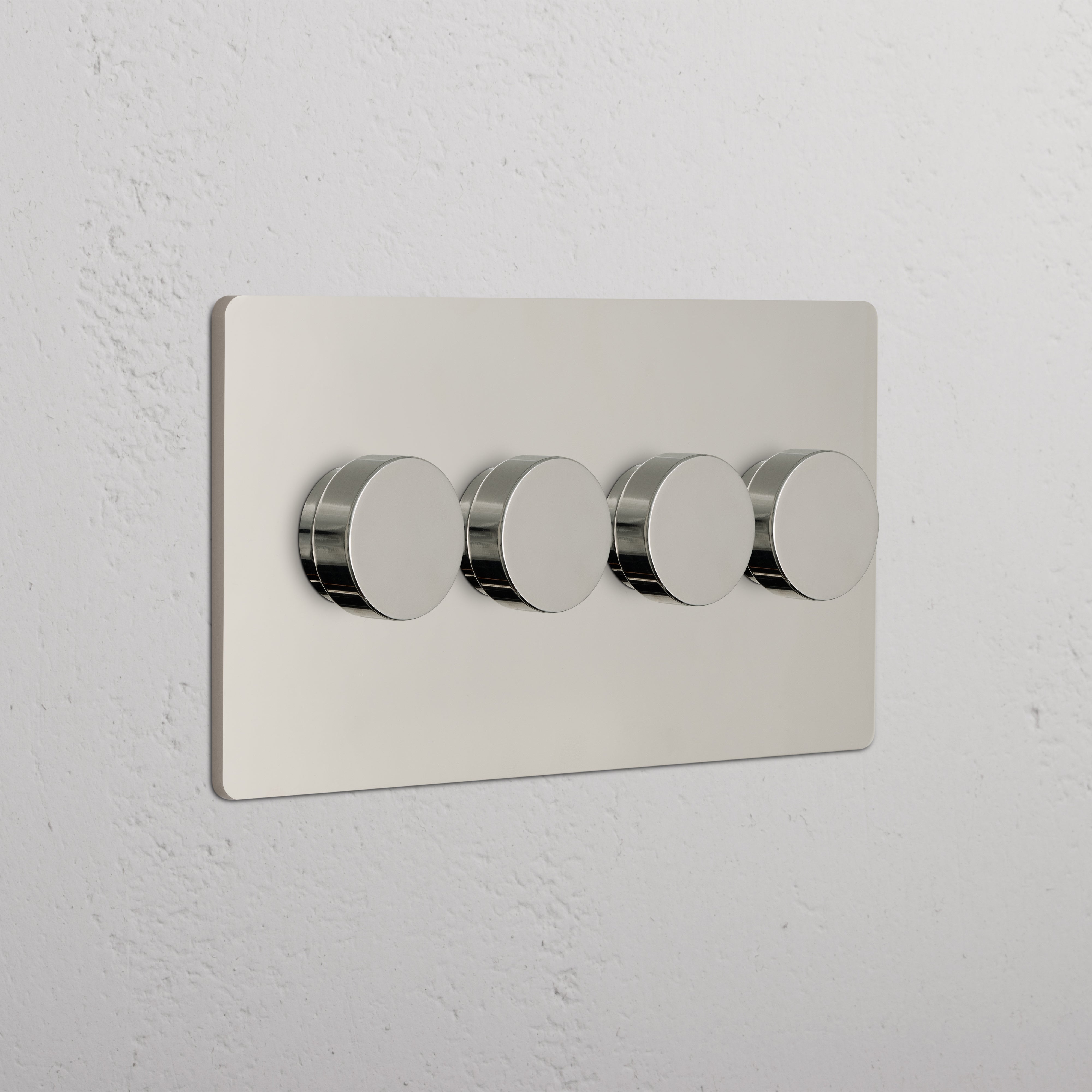 Grove 4G Dimmer Switch in Polished Nickel with four round knobs on a textured white wall.