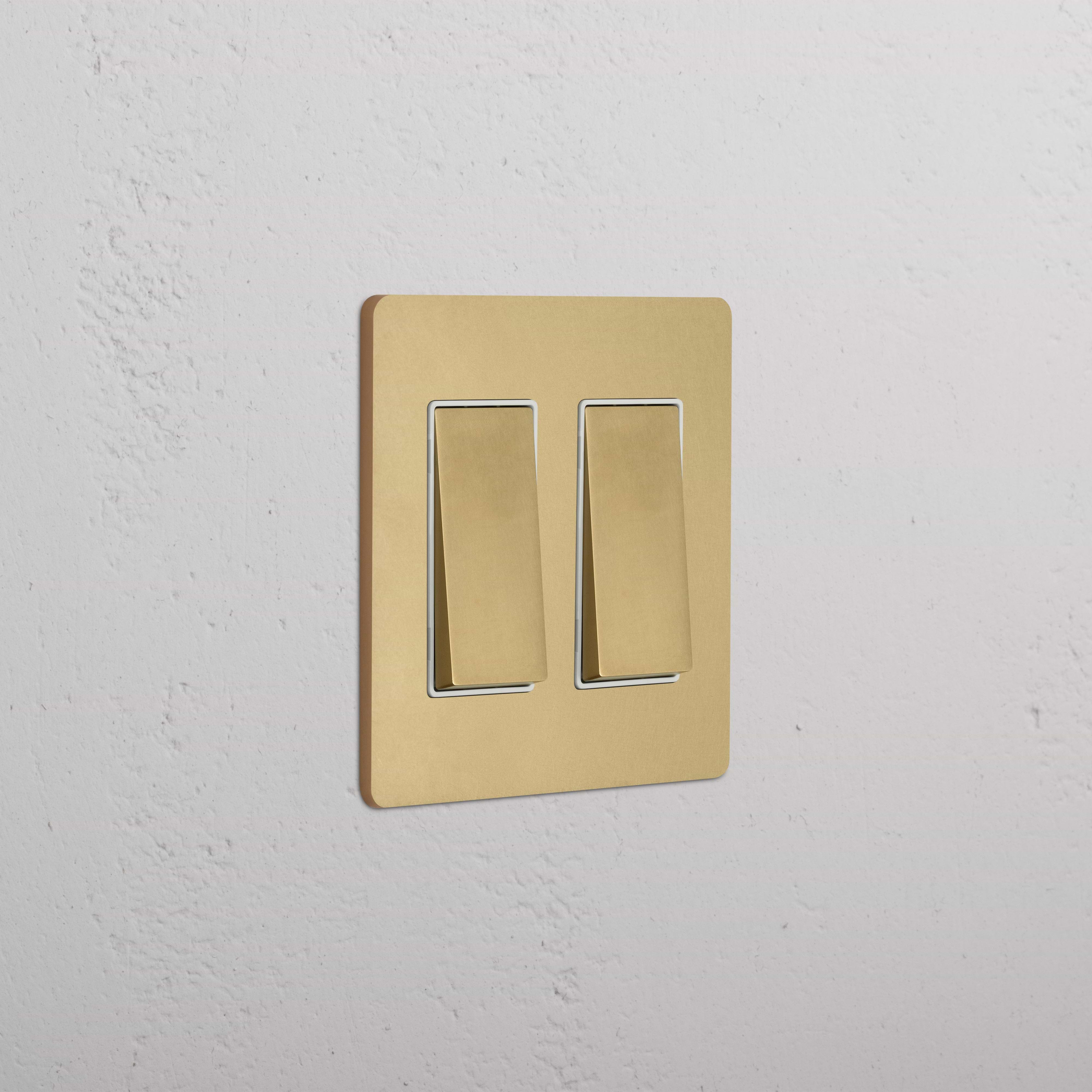Grove 2G Rocker Switch in antique brass white with brushed gold plate and dual rocker toggles.