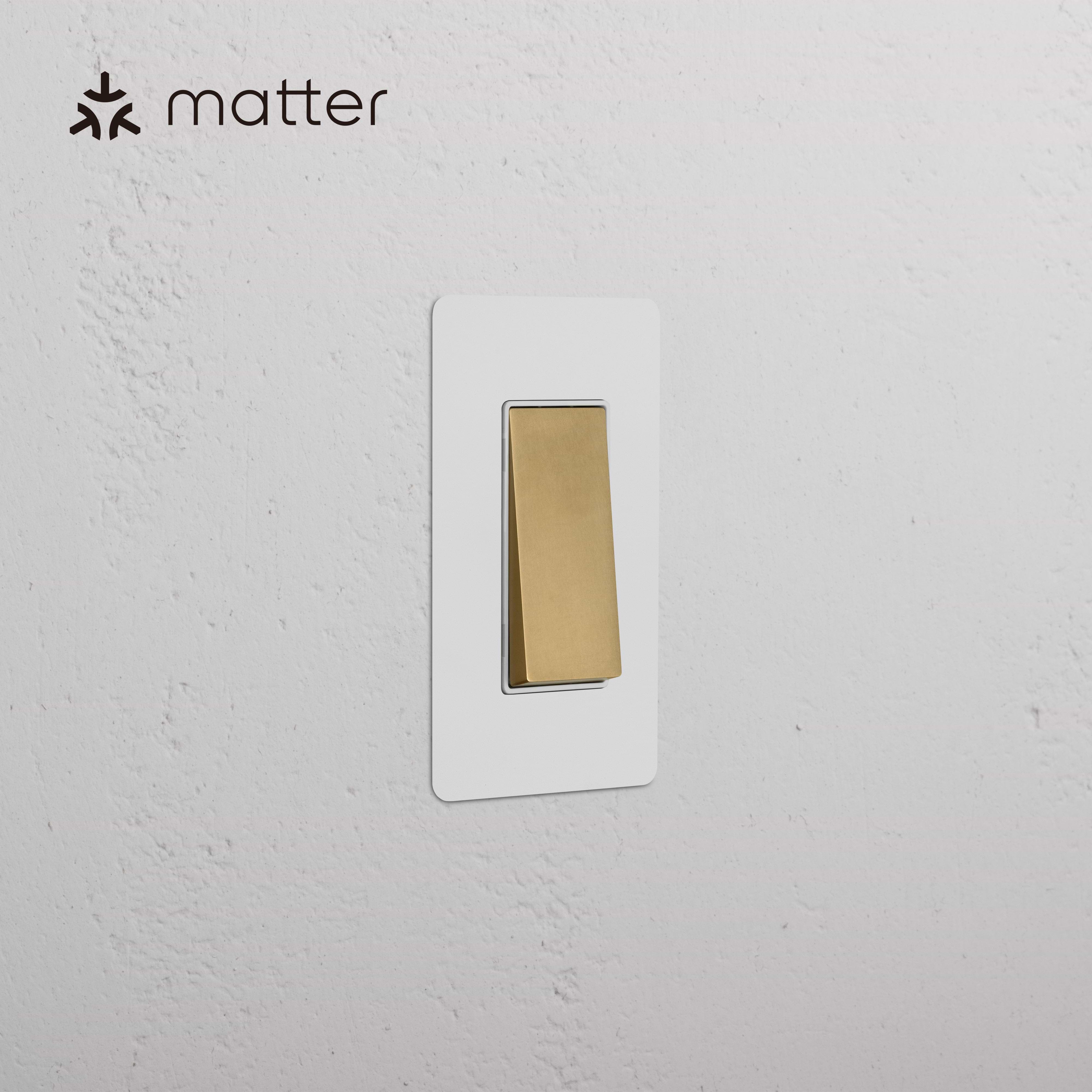 Kew 1G Smart Retractive Rocker Switch in Paintable Antique Brass White with gold switch and white plate.