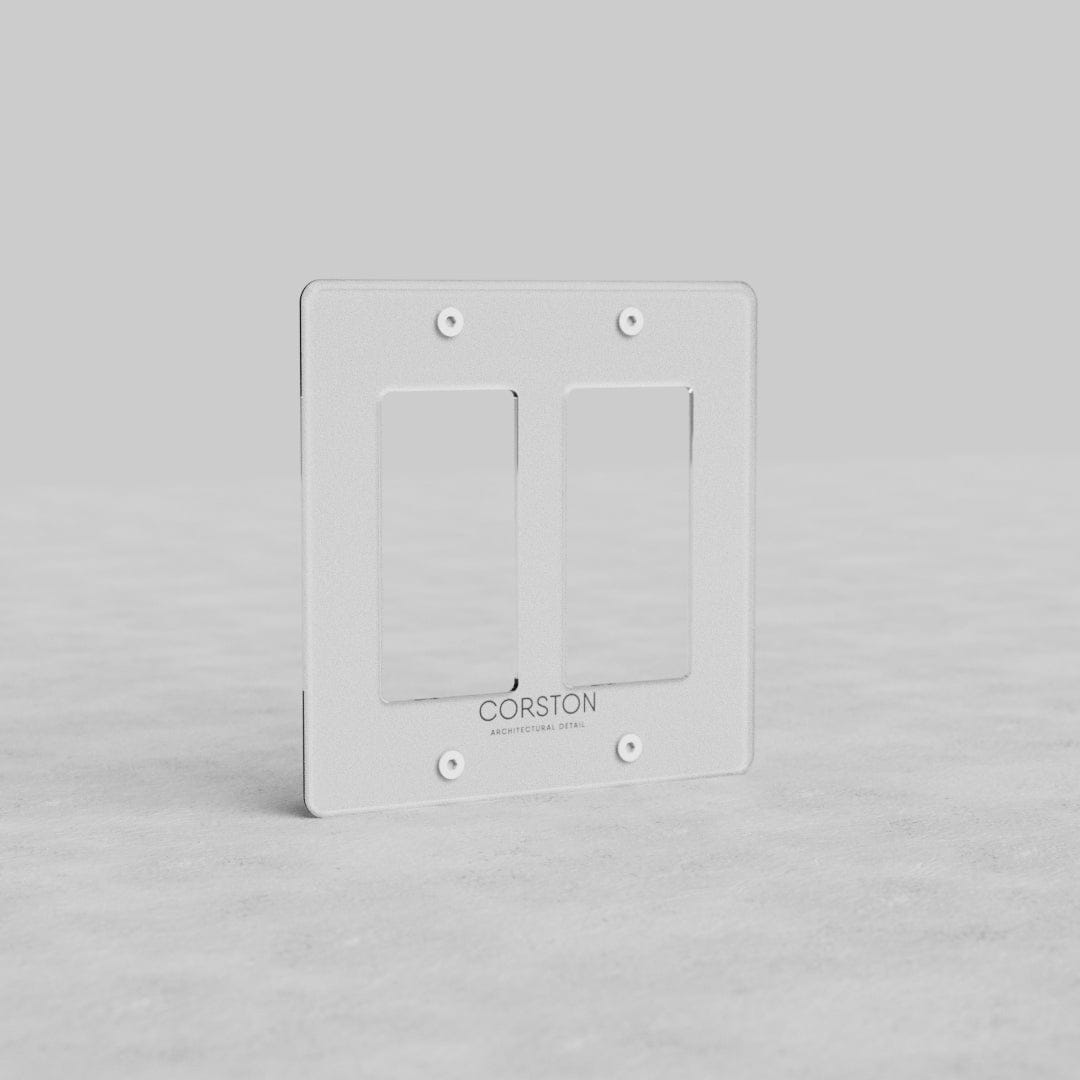 Clear 2G Outlet Plate Kew US with two rectangular openings and four screw holes, by Corston.