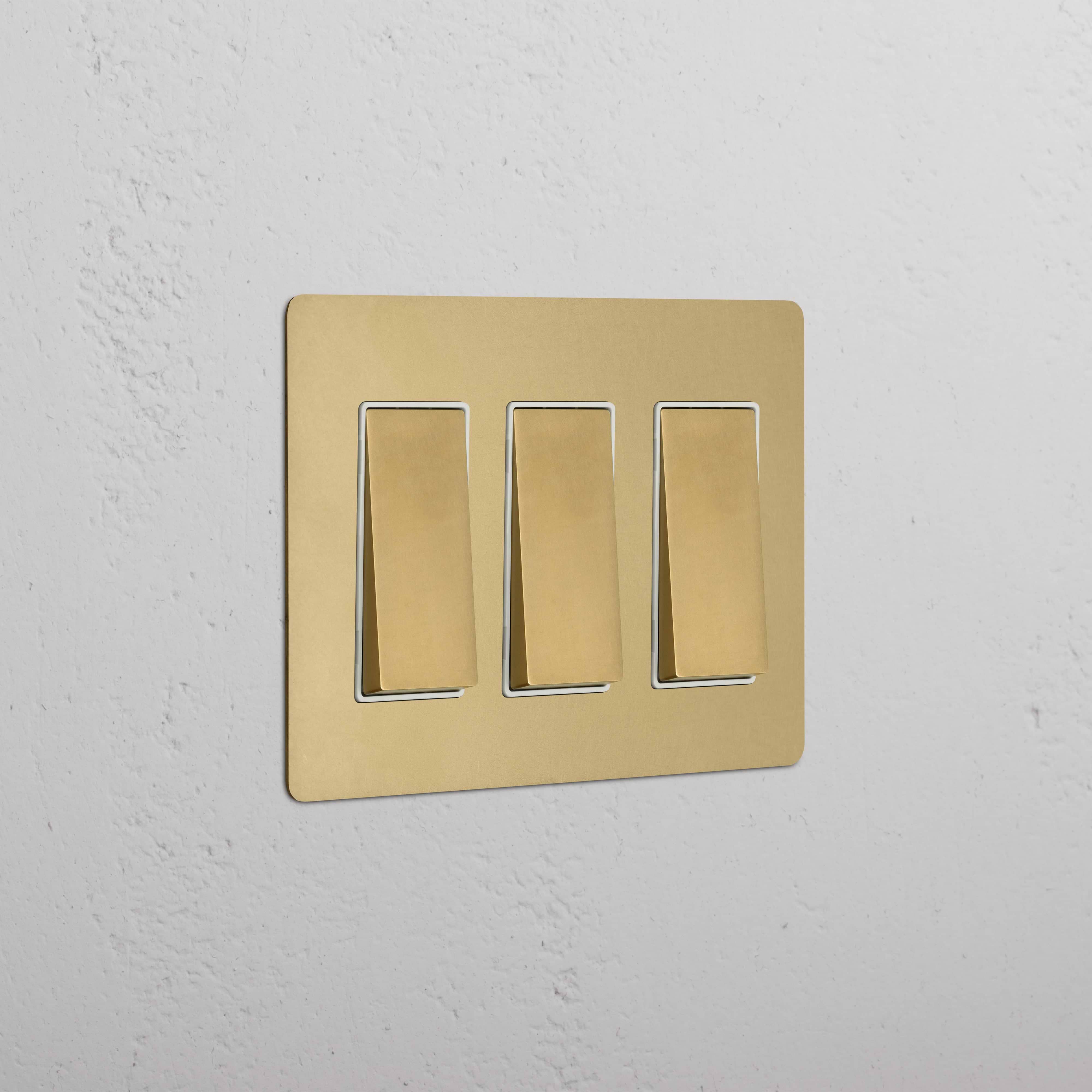 Kew 3G Rocker Switch in antique brass white finish, rectangular faceplate with three rocker switches.