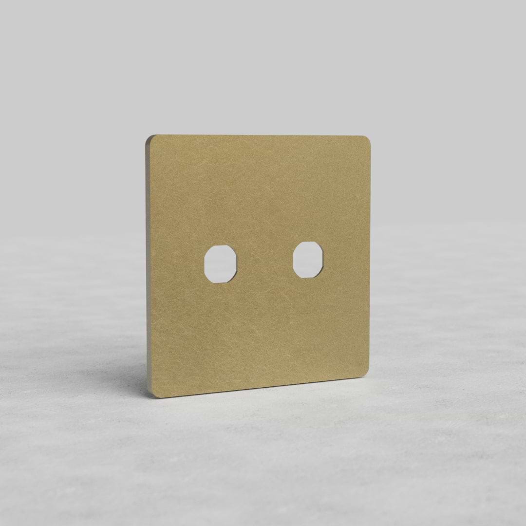2G Switch Plate Grove US in Antique Brass finish, featuring two switch apertures, on a light surface.