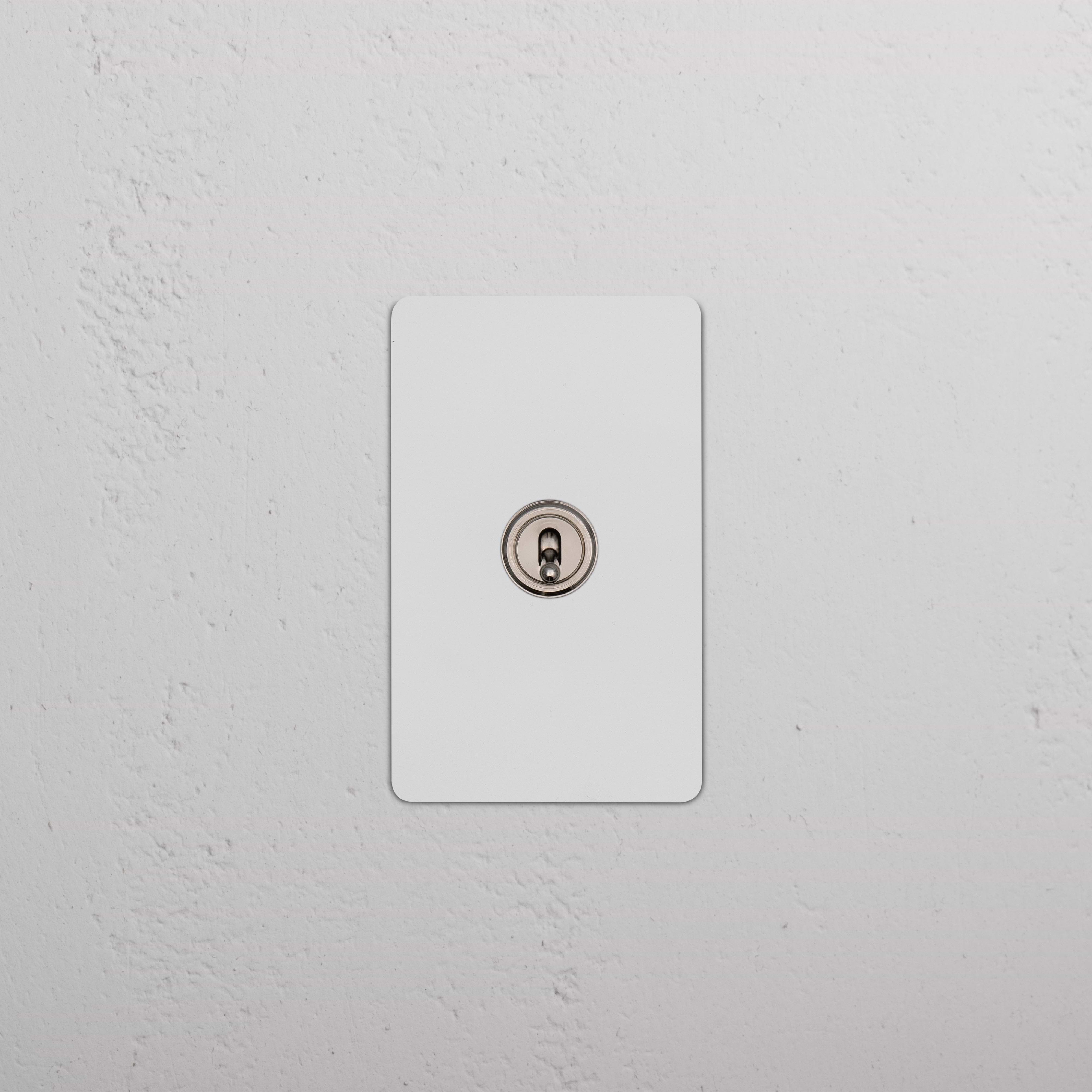 Kew 1G Double Pole Toggle Switch with paintable polished nickel finish on a white wall plate.