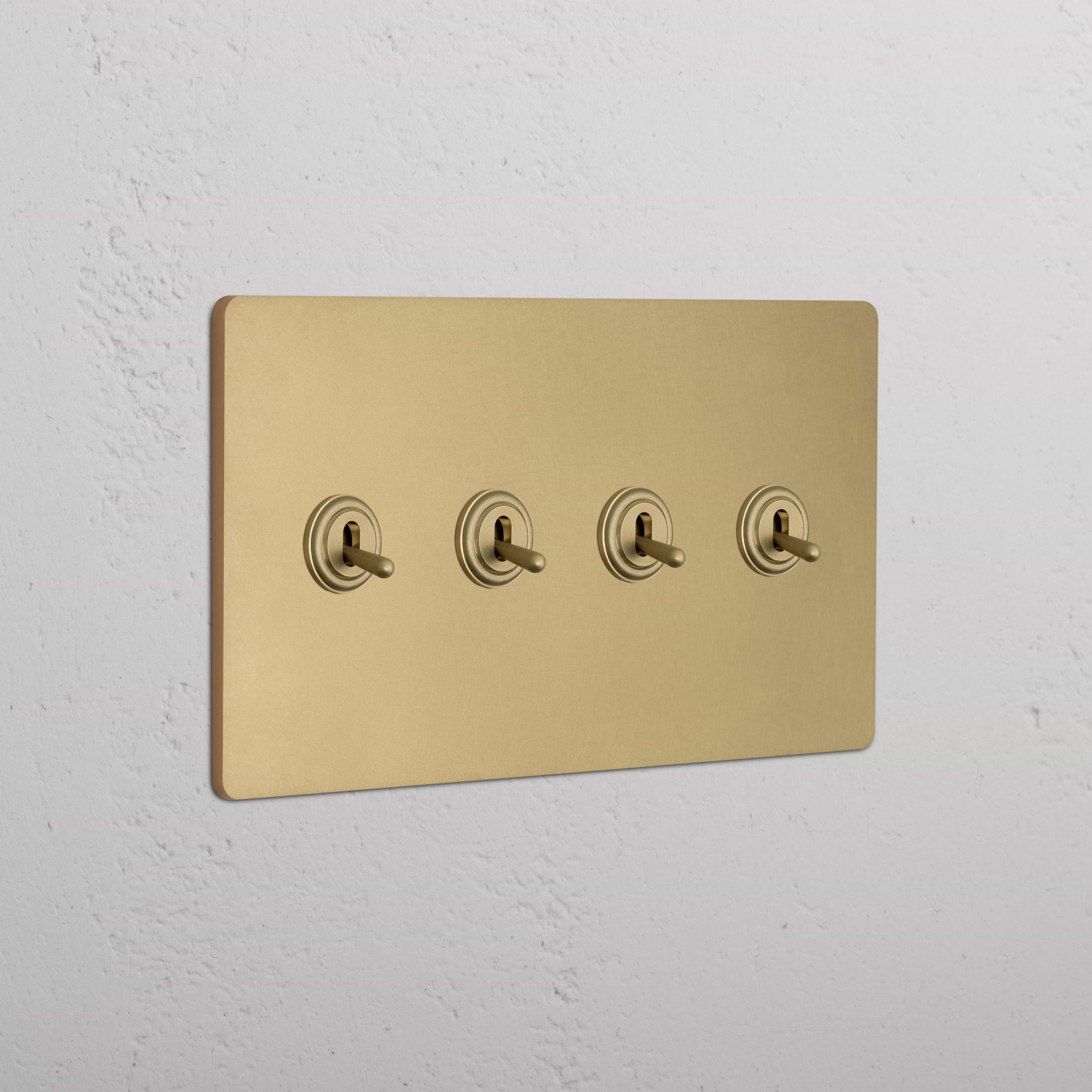 Grove 4G Toggle Switch in antique brass, featuring four toggles on a matte gold switch plate.