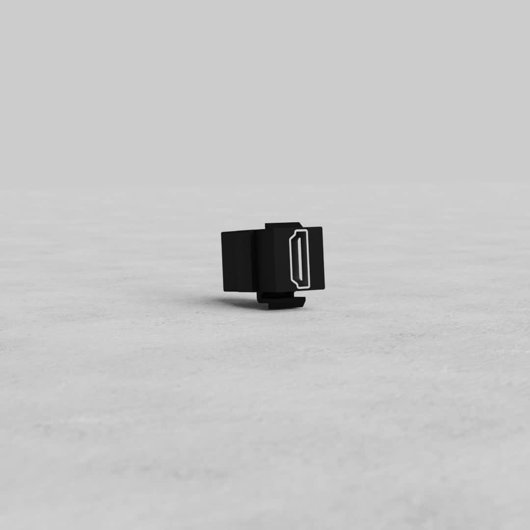 Black HDMI Keystone Module standing upright on a light gray surface with a plain gray background.