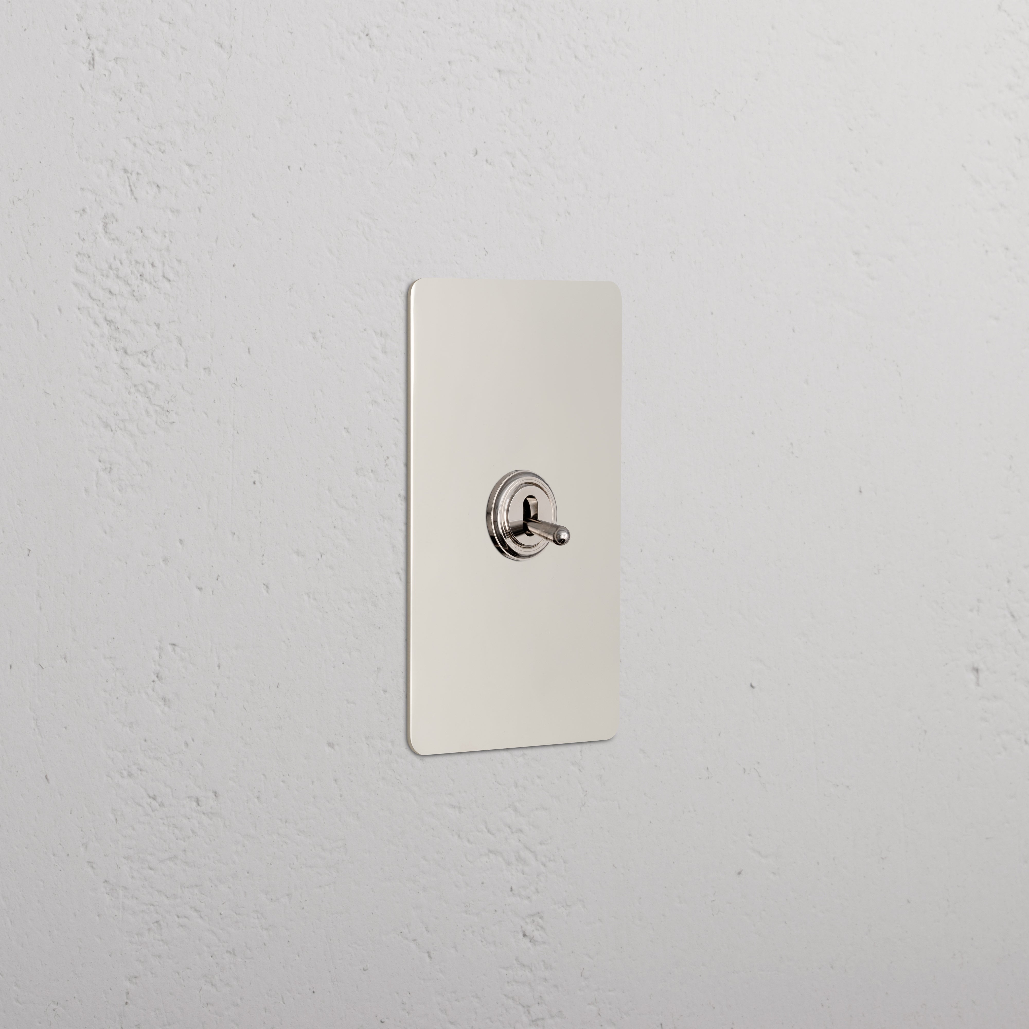 Kew 1G Four Way Toggle Switch in polished nickel finish, rectangular plate, mounted on a white wall.