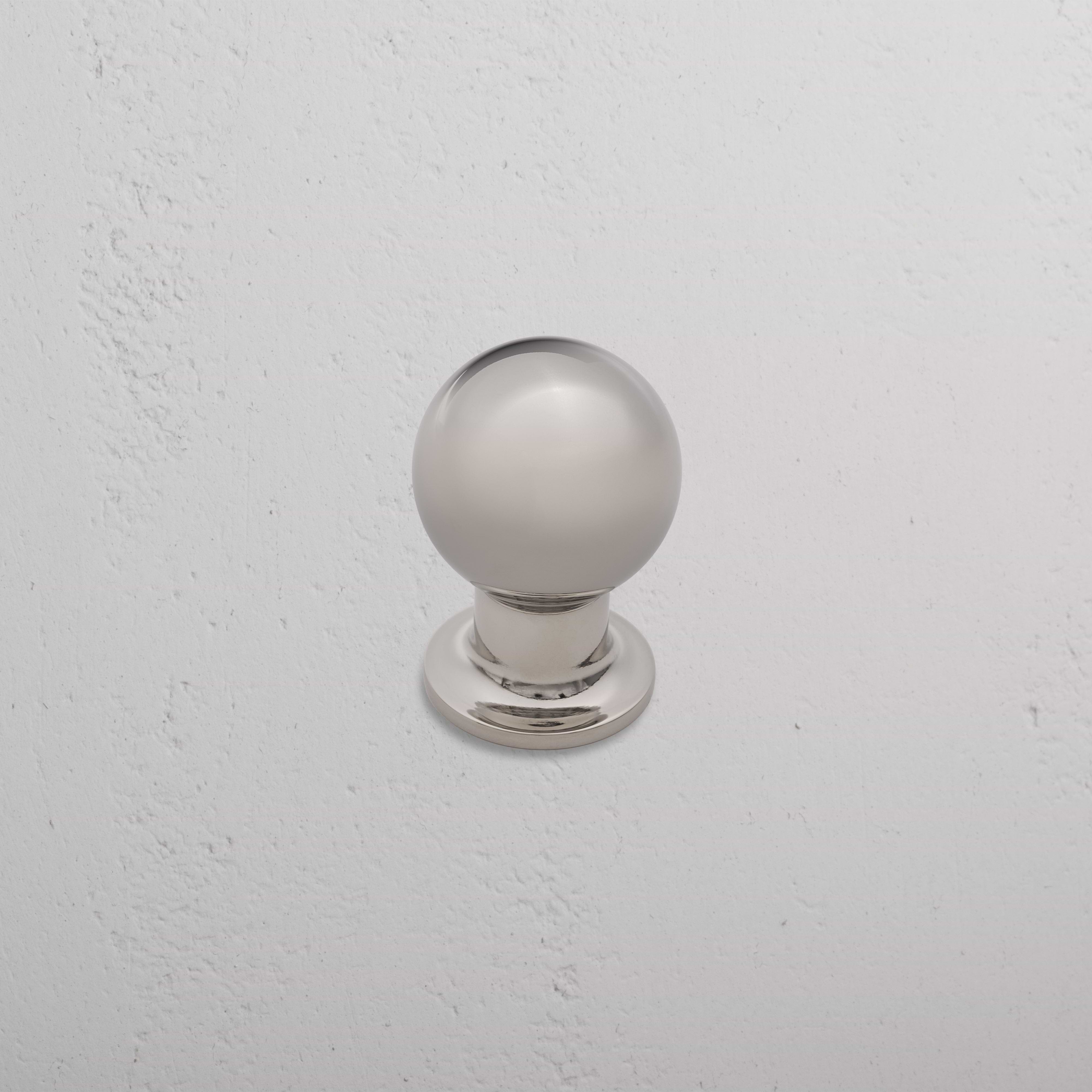 Bayswater Furniture Knob Medium in polished nickel, mounted on a textured white wall.