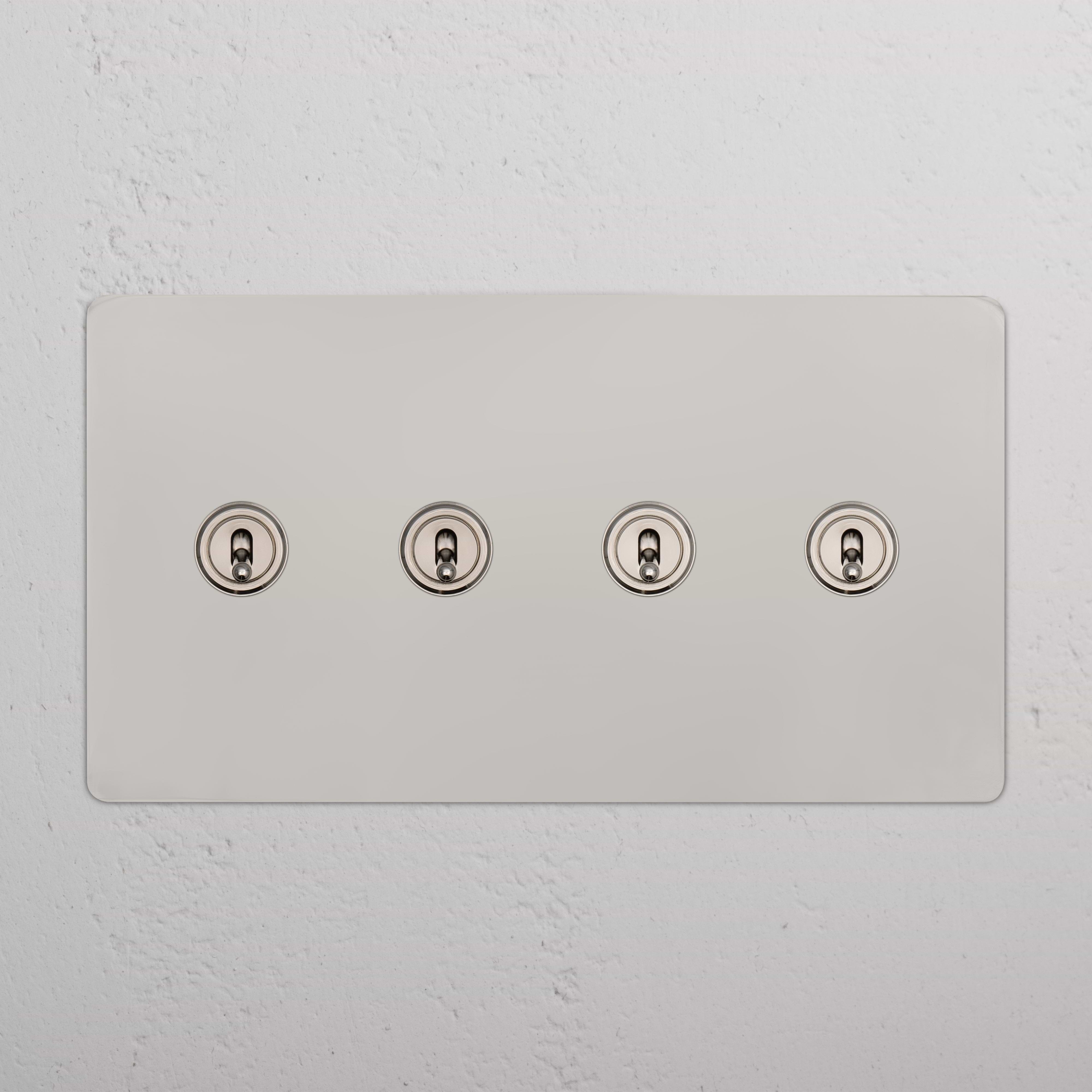 Kew 4G Toggle Switch in Polished Nickel with four round toggles on a rectangular wall plate.