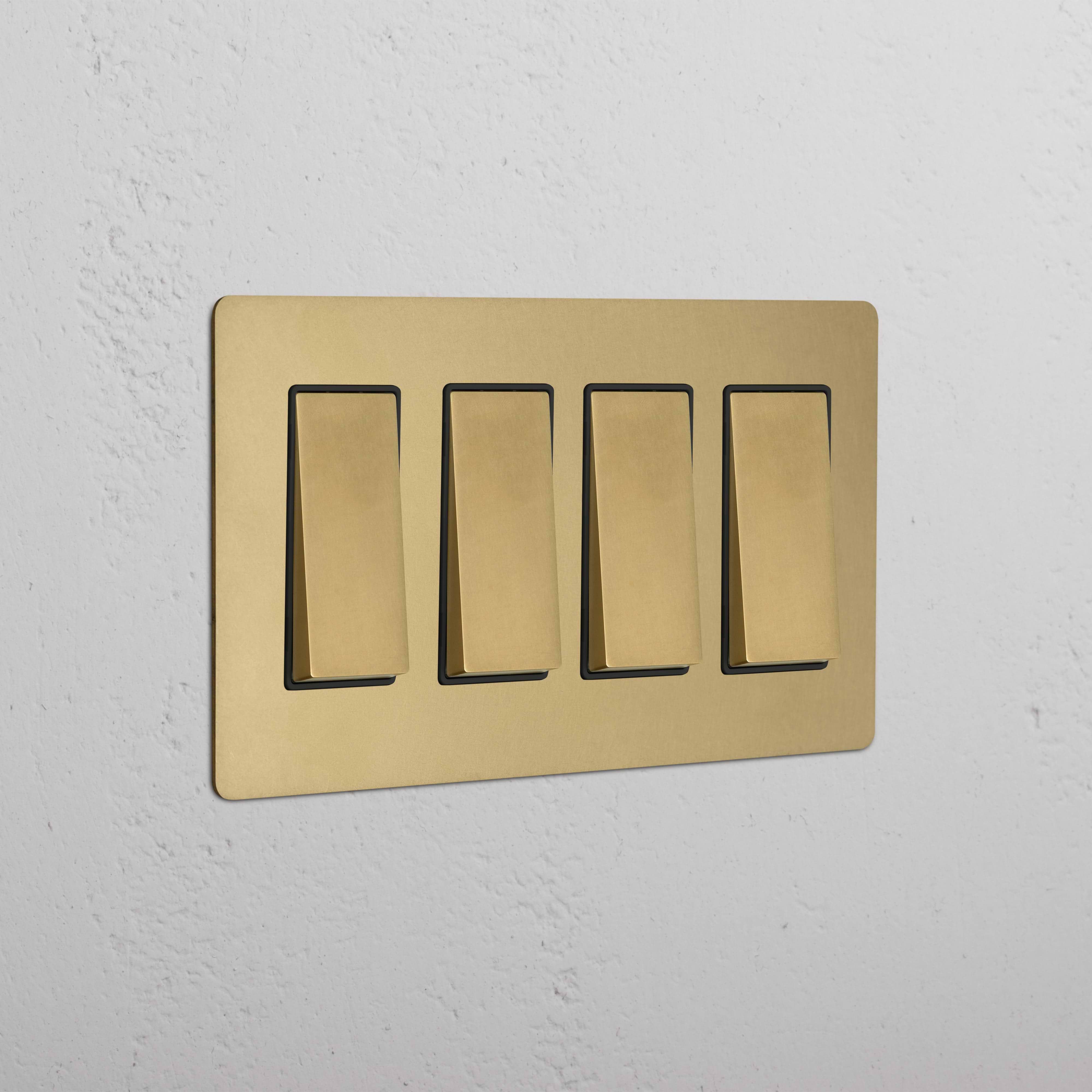Kew 4G Rocker Switch in antique brass black with four rectangular switches, shown on a white wall.