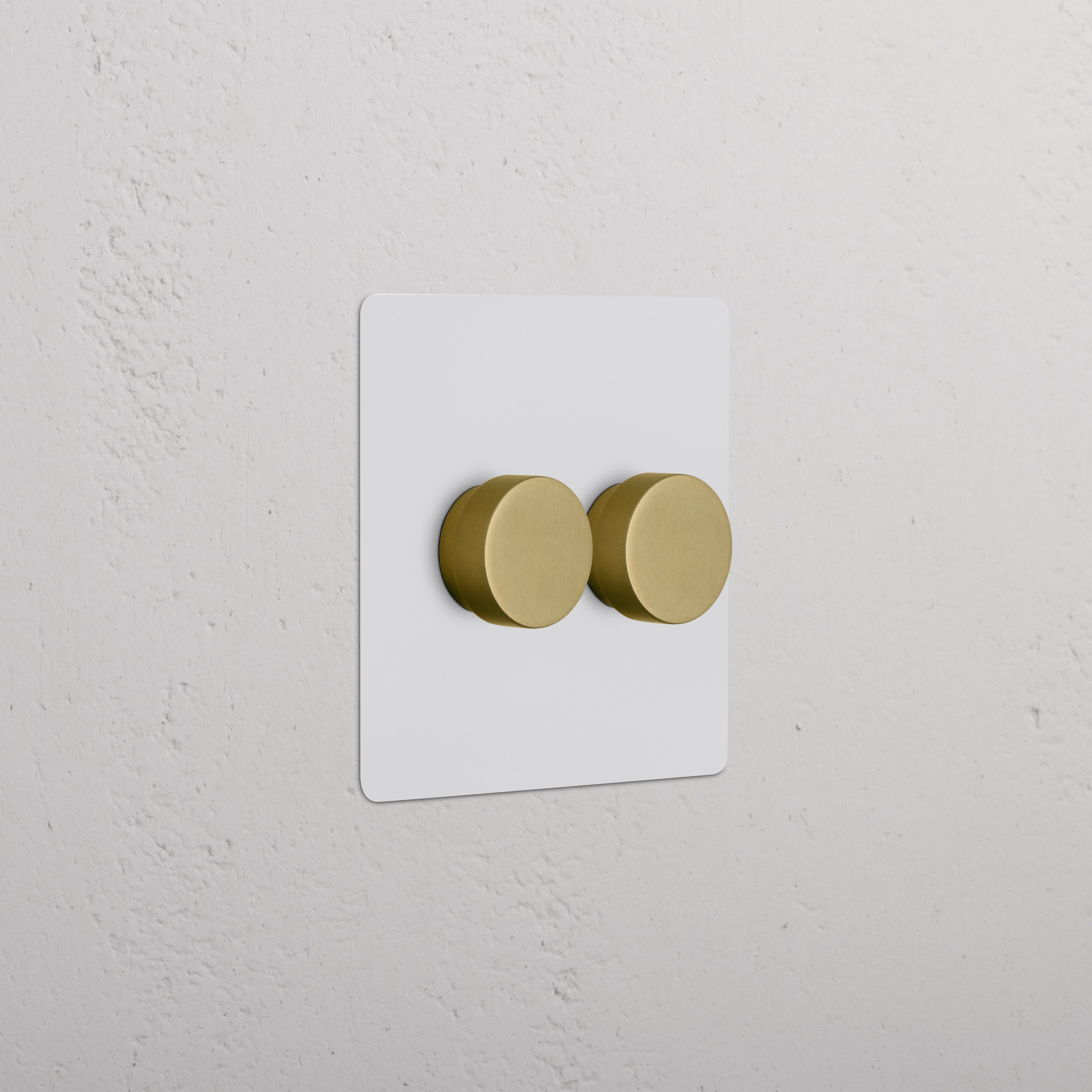 Kew 2G Dimmer Switch with two paintable antique brass knobs on a white wall plate.