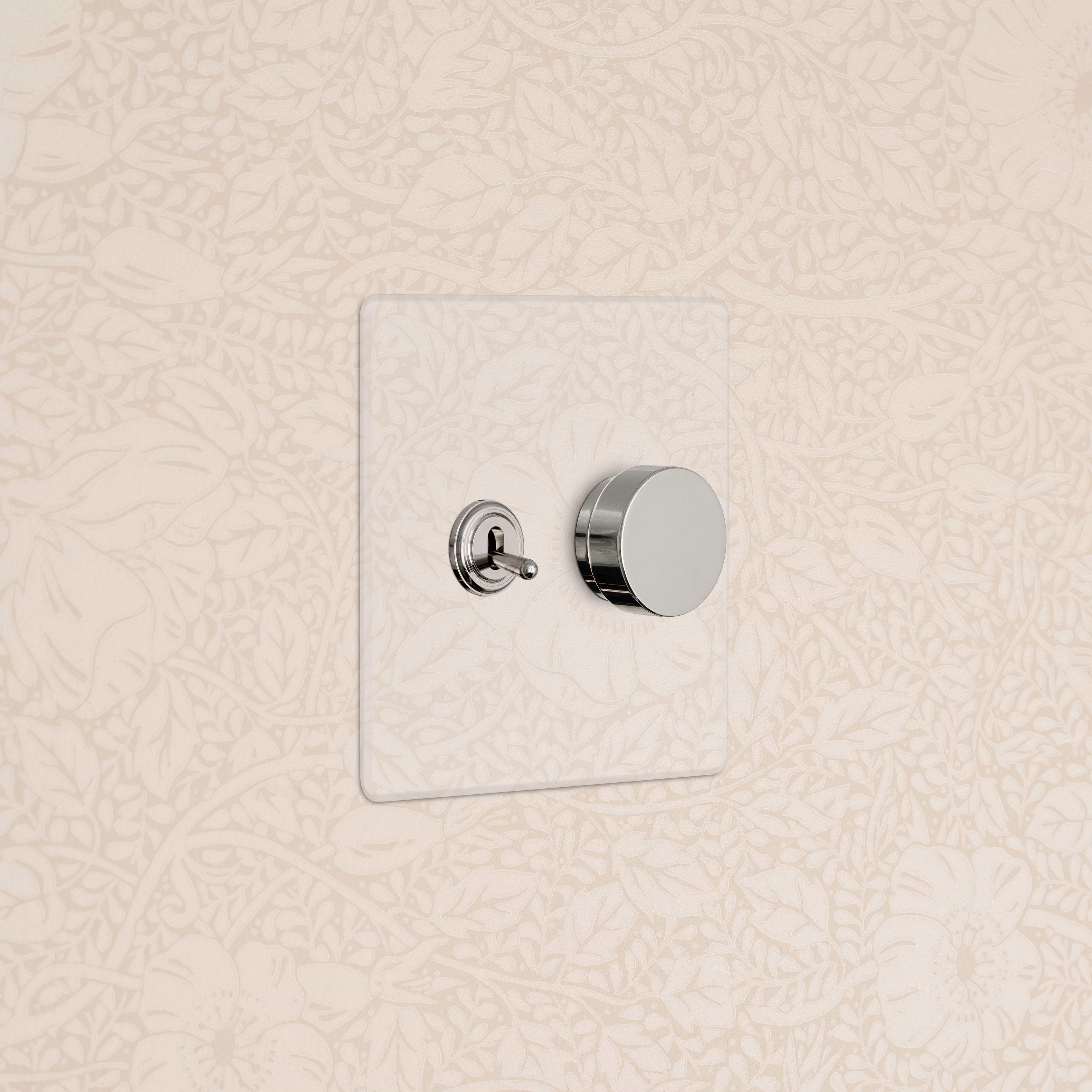 Kew 2G Toggle & Dimmer Switch in clear polished nickel with metallic toggle and round dimmer on clear plate.