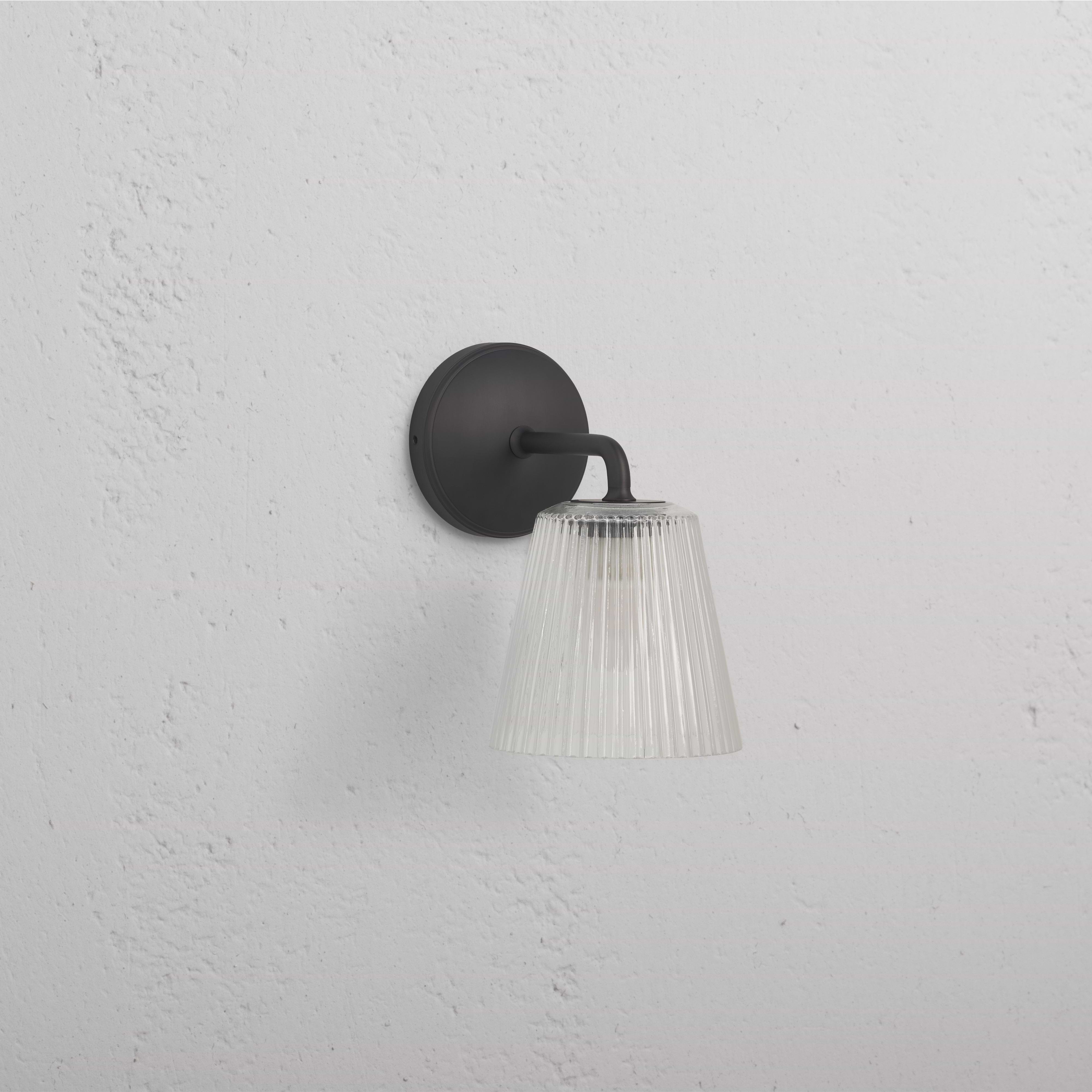 Richmond Medium Wall Light Fluted Glass in bronze with ribbed glass shade and bronze base, wall-mounted.