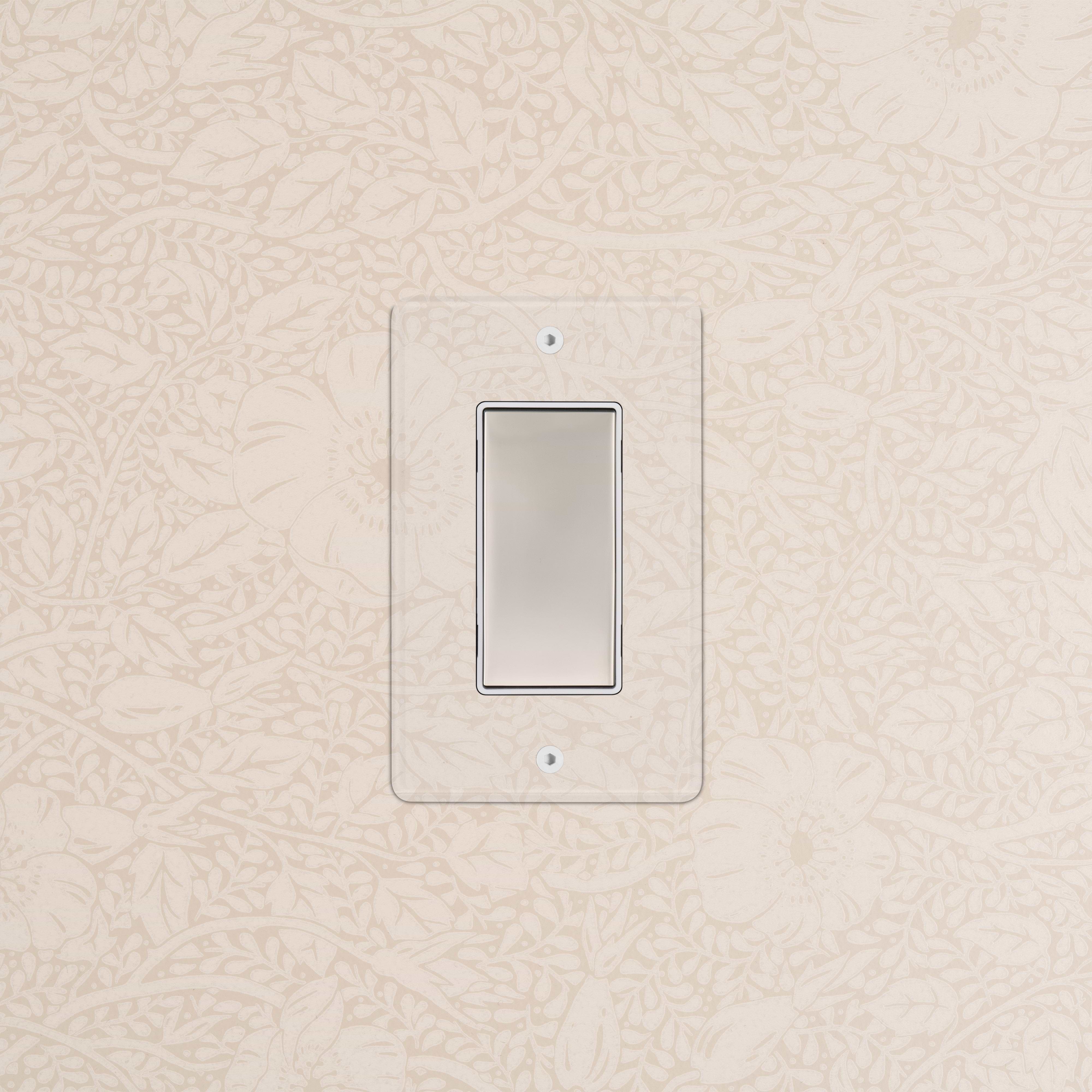 Kew 1G Center Retractive Rocker Switch with clear polished nickel white plate on a patterned beige wall.