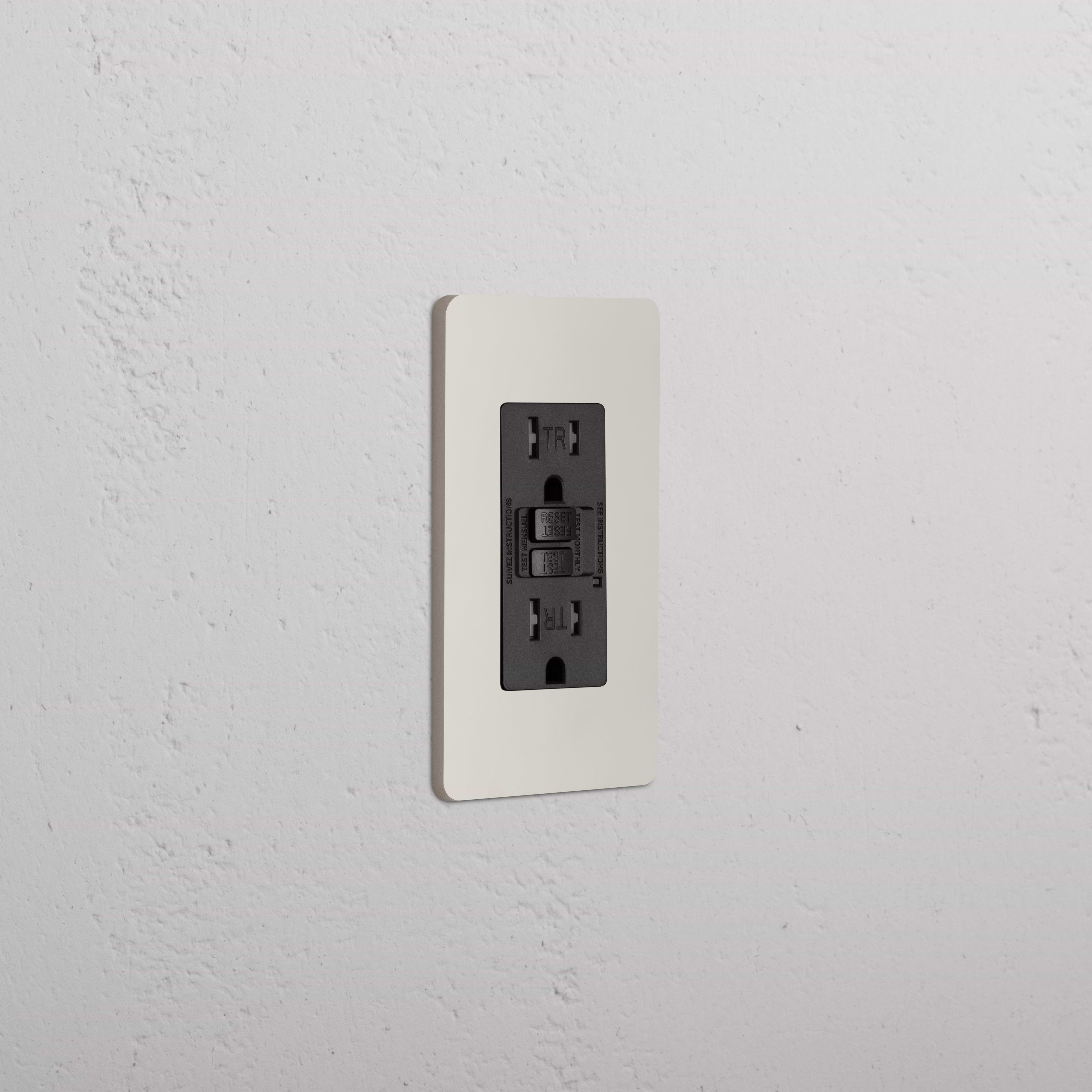 Grove 1G 15A GFCI Outlet in Polished Nickel Black with white cover plate on a textured white wall.