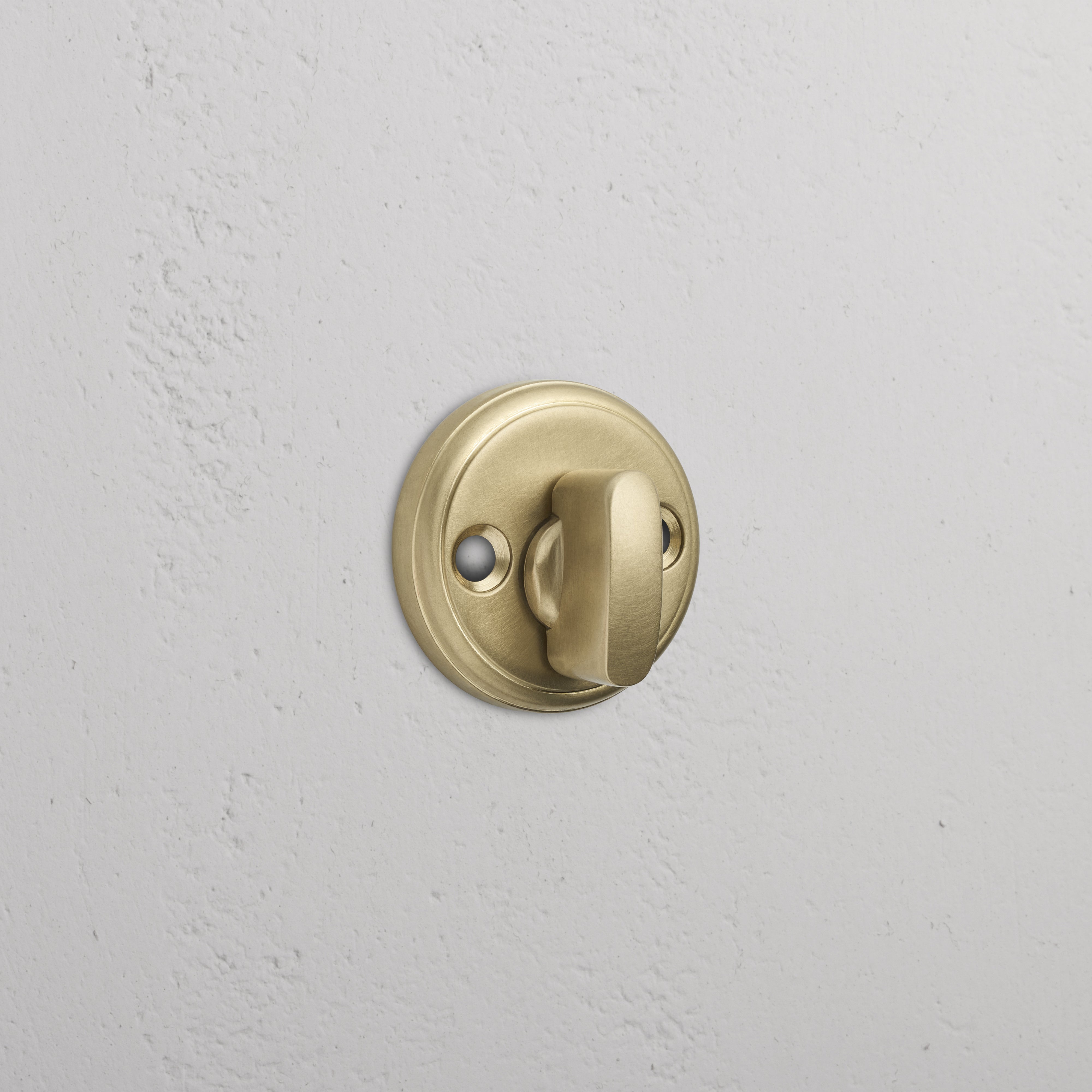 Canning Privacy Deadbolt in Antique Brass finish installed on a white wall.