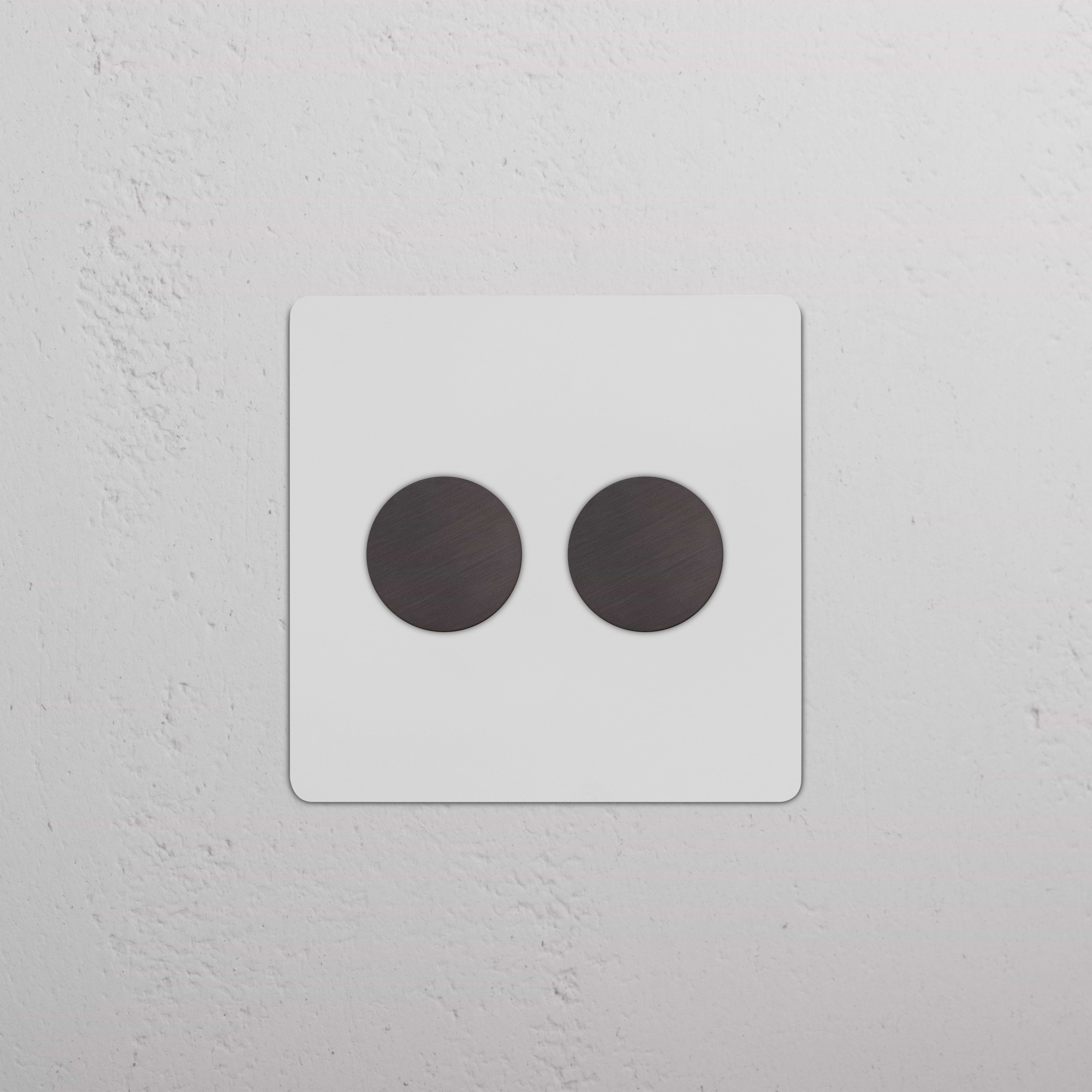 Kew 2G Dimmer Switch - Paintable Bronze with two round dimmer knobs on a square, bronze-finish plate.