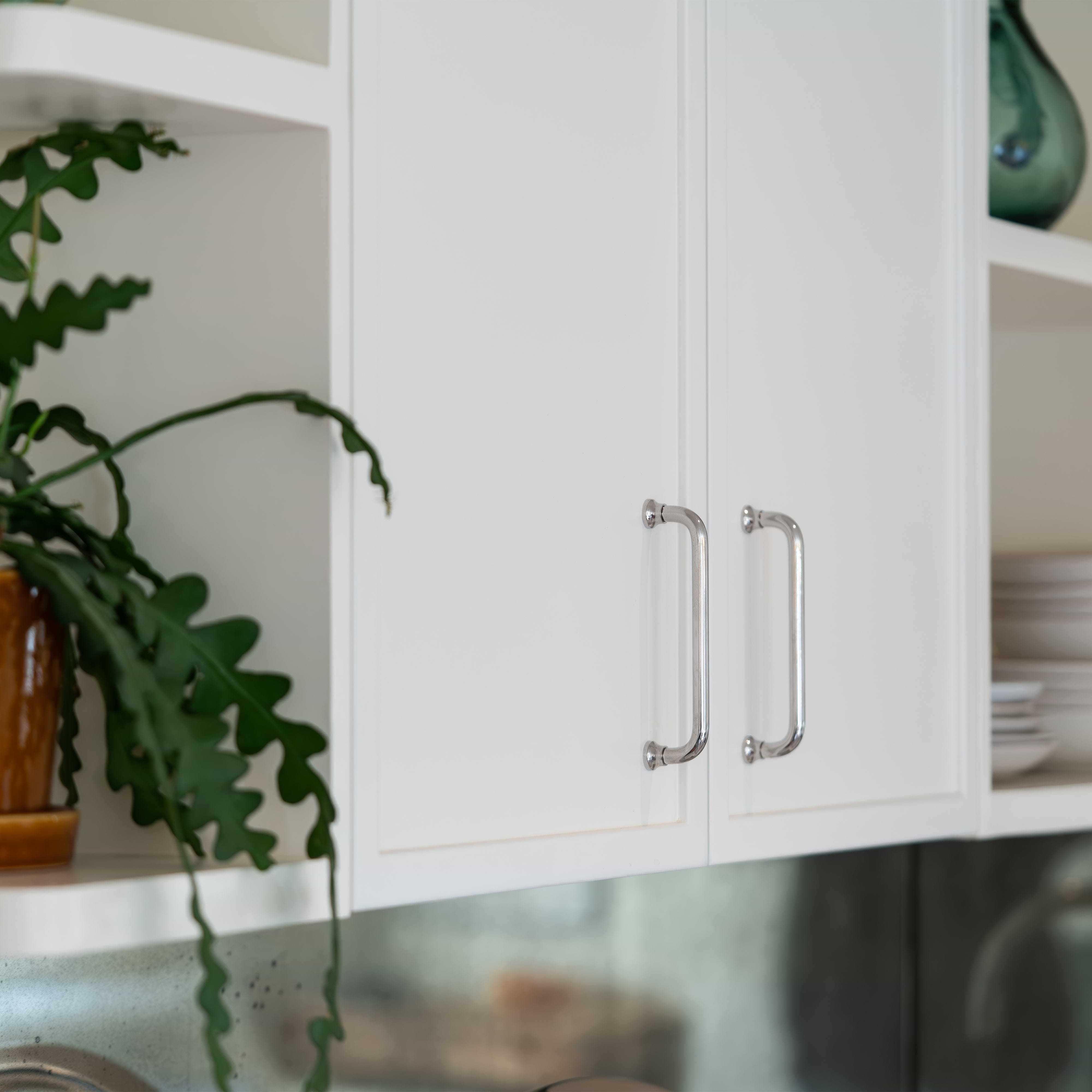 Close-up of a Sycamore Furniture Handle Small in polished nickel finish installed on a cabinet drawer.