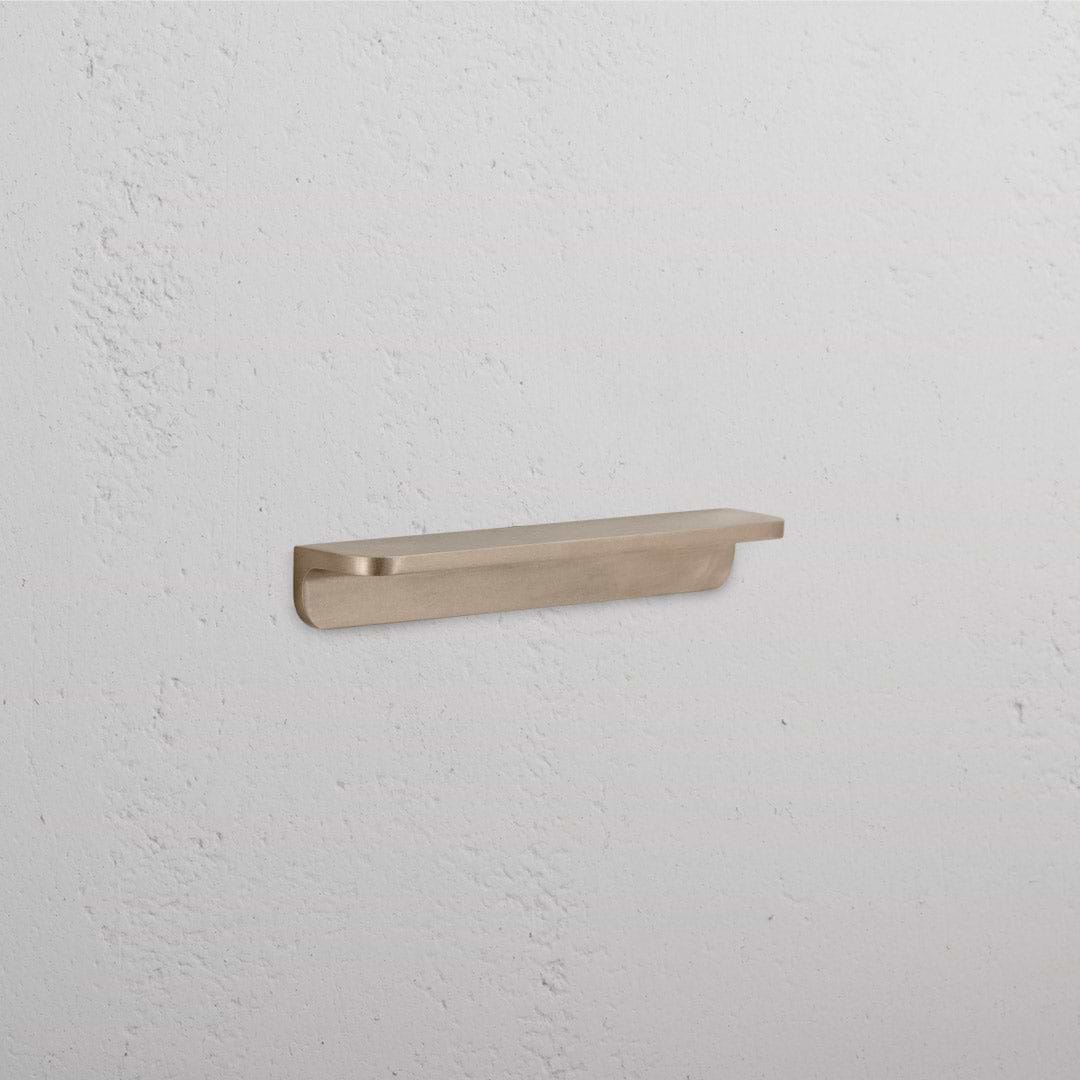 Small Oxford Furniture Handle in antique brass finish, featuring a slim, rounded design, shown on a white background.