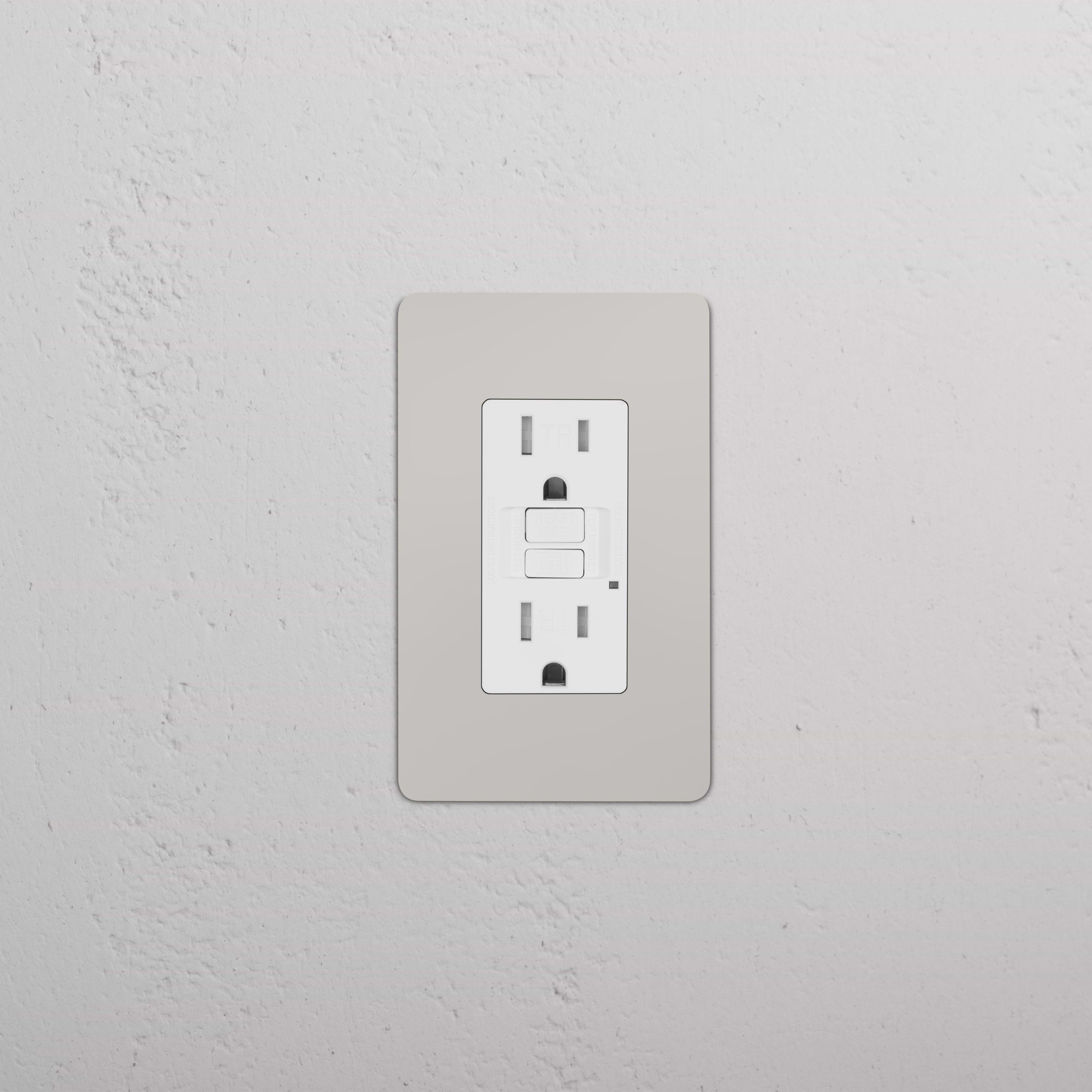 Kew 1G 15A GFCI Outlet in polished nickel white with two sockets and reset/test buttons on a wall.