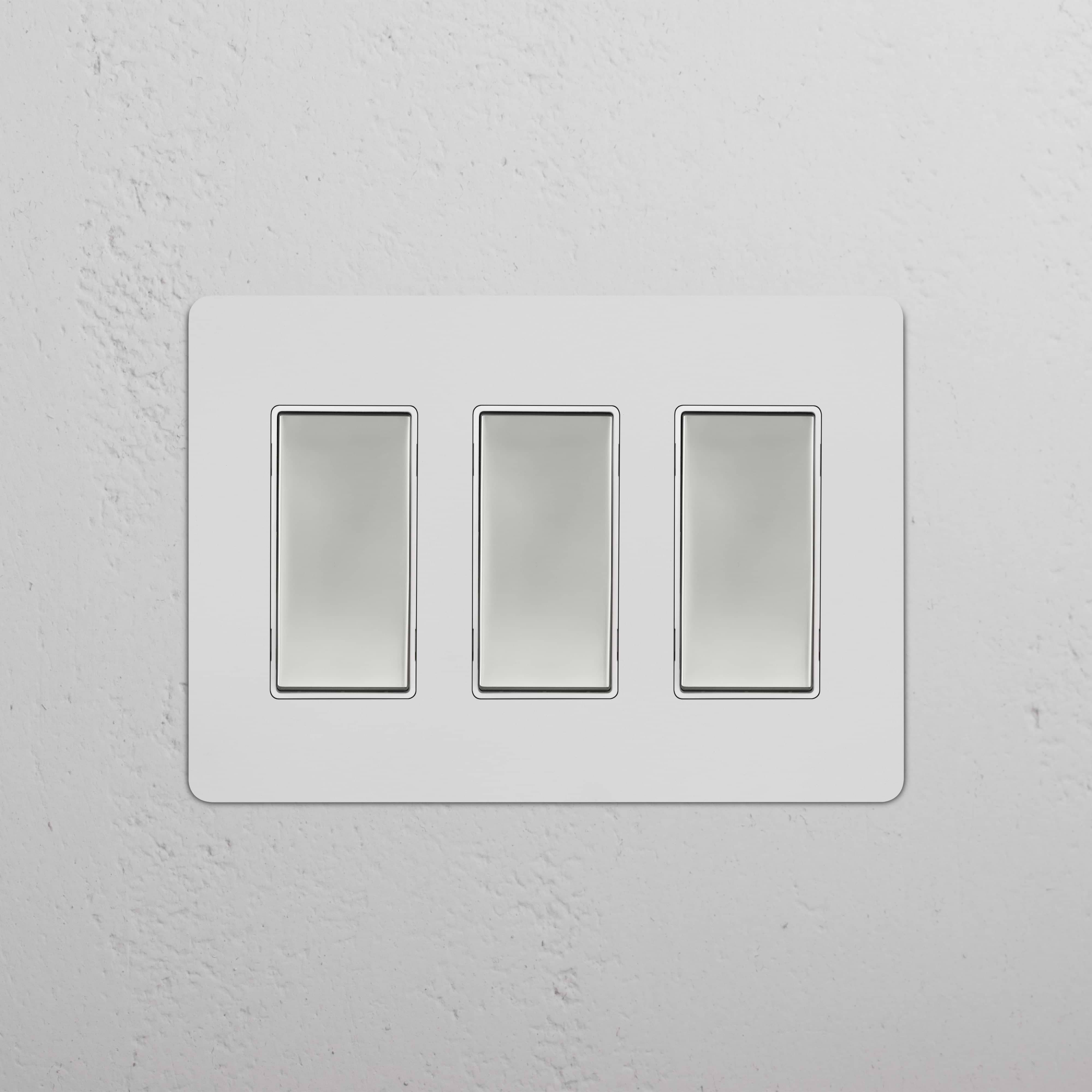 Kew 3G Rocker Switch in paintable polished nickel white, featuring three rectangular rocker switches.