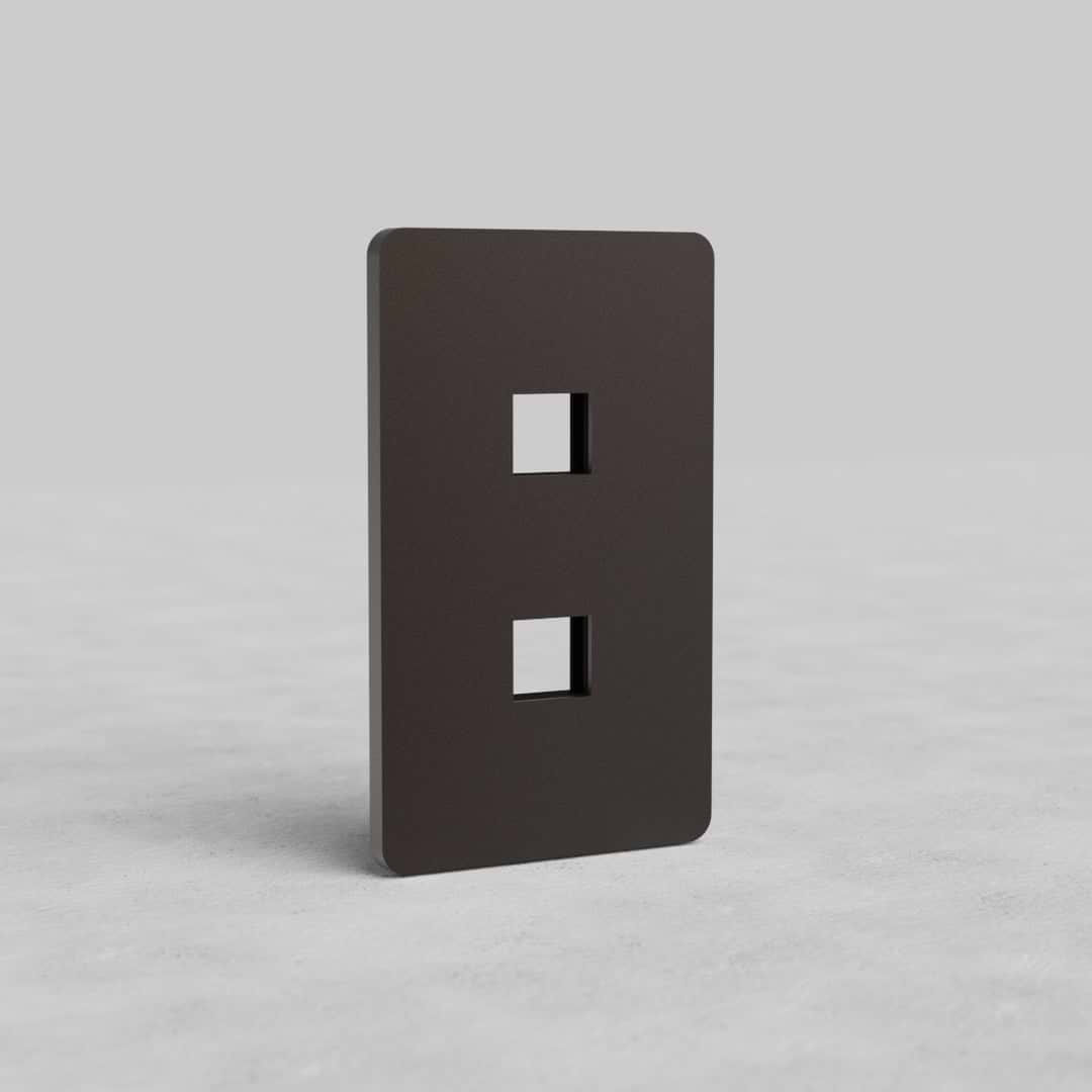 Bronze 1-gang faceplate with two keystone openings for Grove US, shown upright on a gray background.