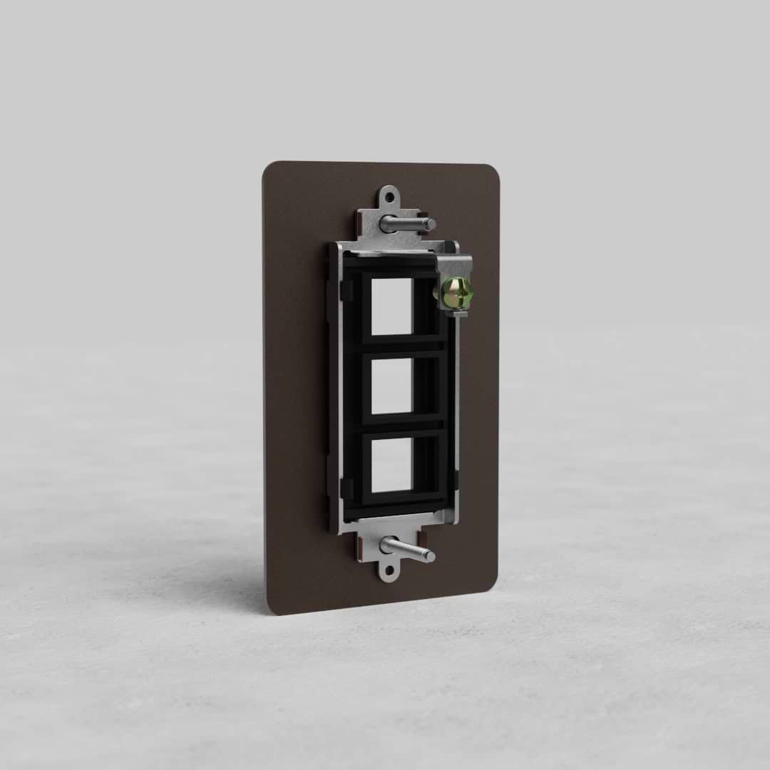 Bronze 1-gang 3-port Keystone wall plate (Kew US), shown with three empty keystone slots, on a gray background.