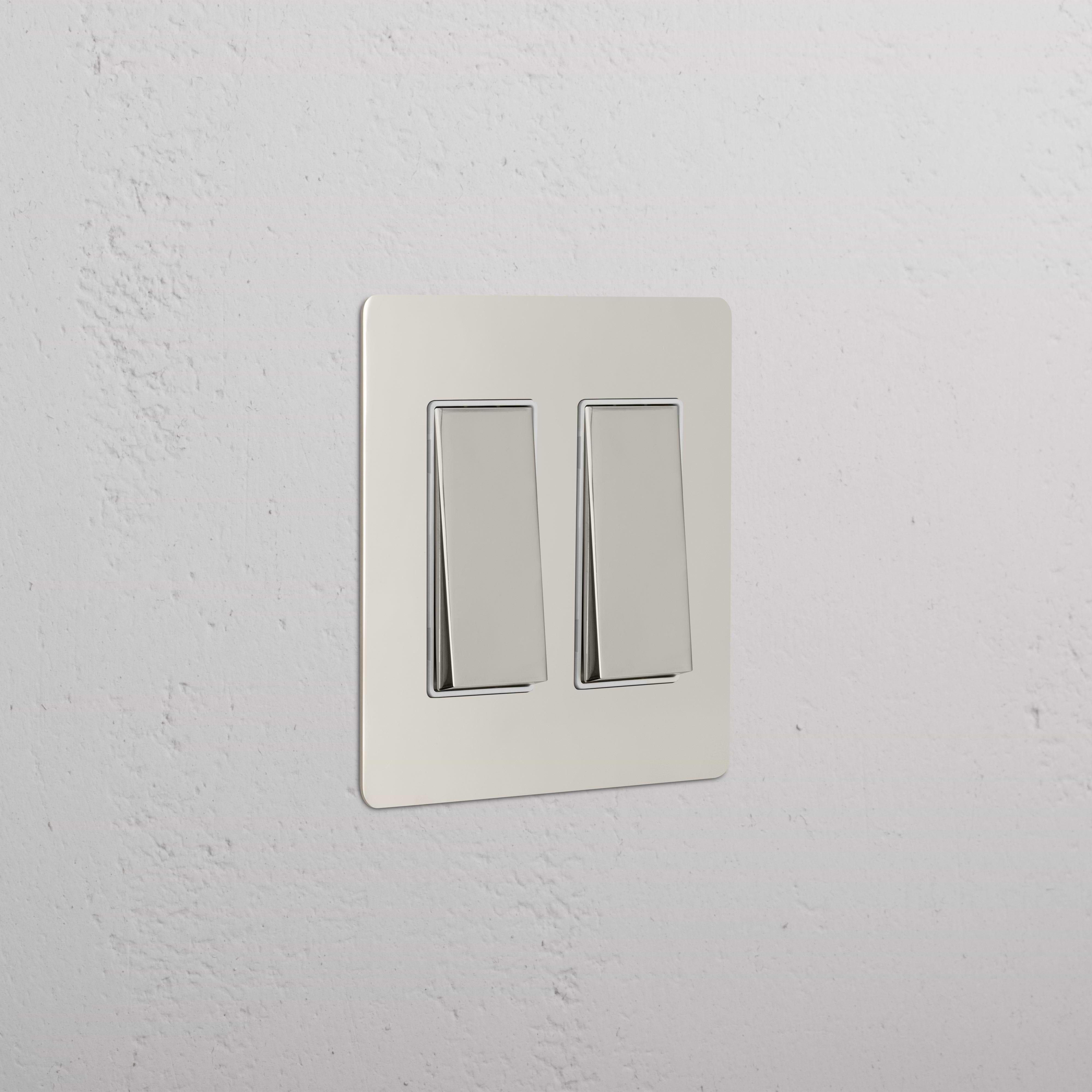 Kew 2G Rocker Switch in polished nickel with white finish, shown mounted on a white textured wall.