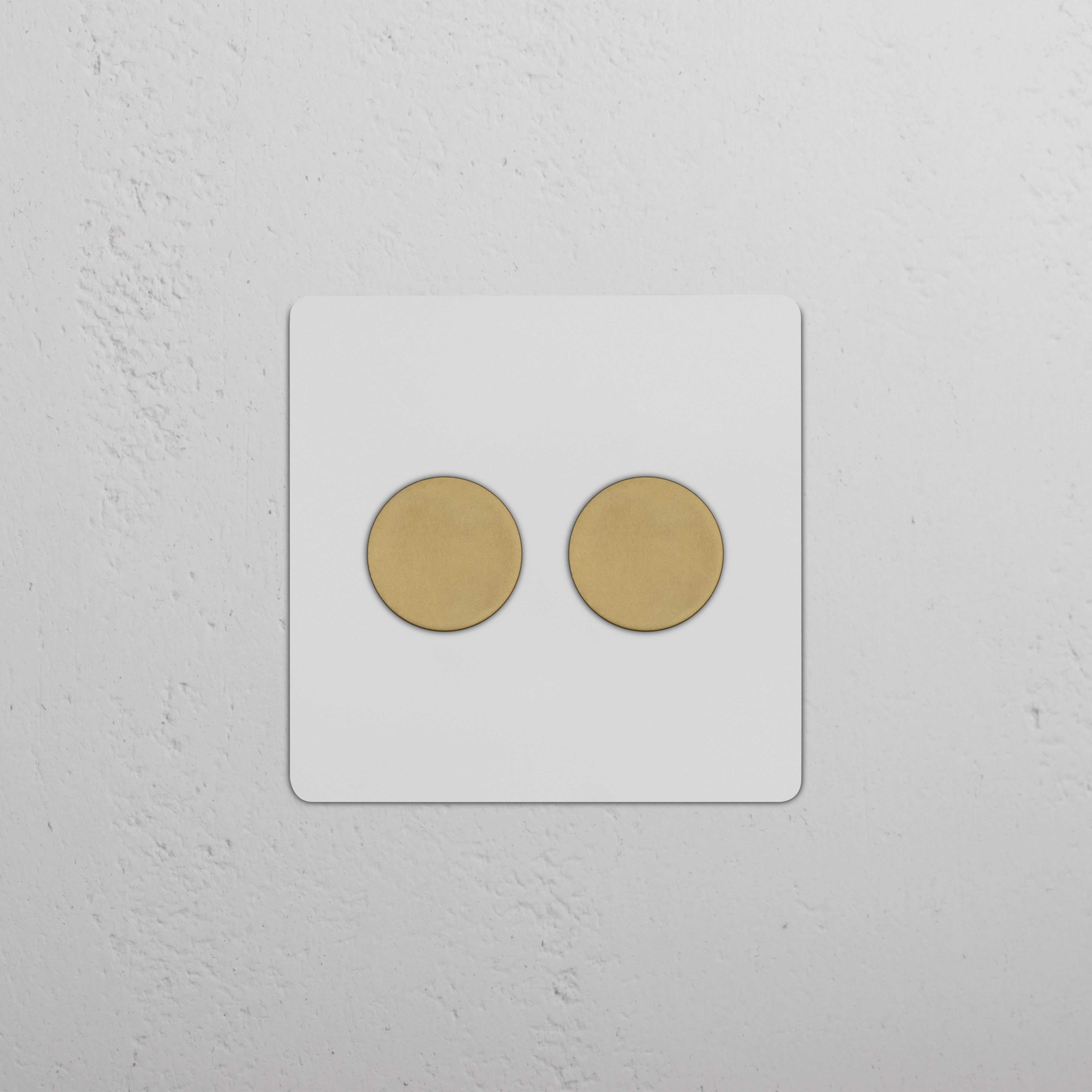 Kew 2G Dimmer Switch in paintable antique brass with two round dials on a white background.