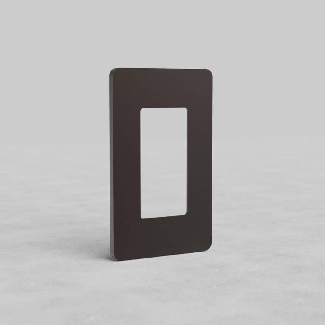 Bronze 1G Outlet Plate Grove US with a central cut-out, displayed upright on a light gray surface.