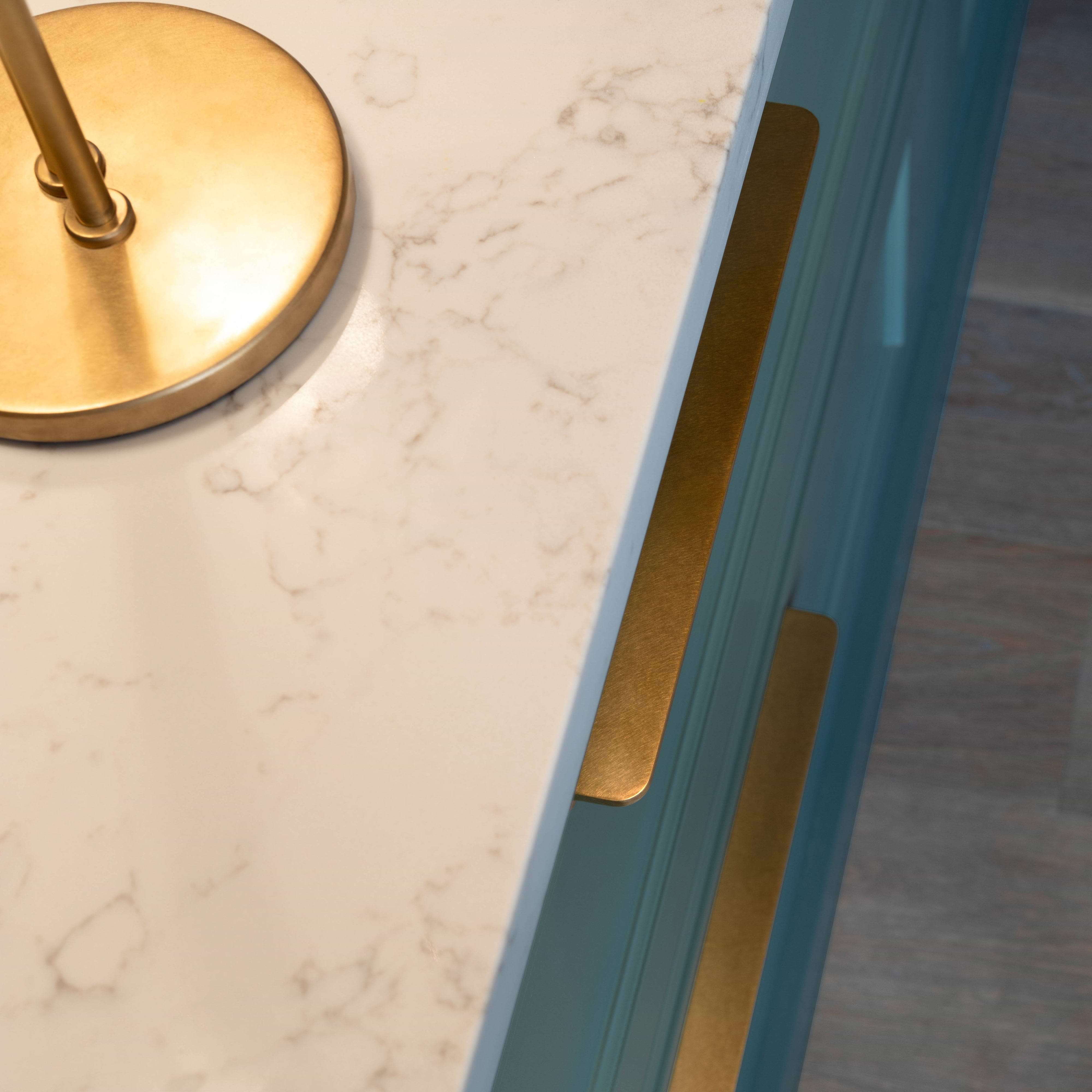 Large Oxford Furniture Handle in antique brass finish mounted on teal cabinetry.